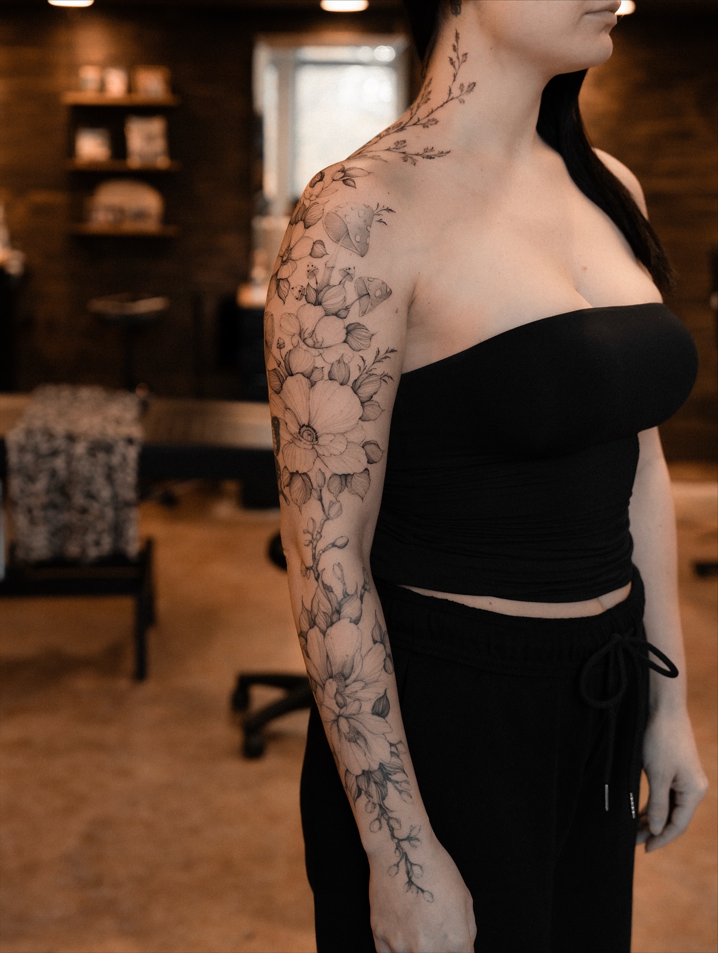 Floral bouquet black and grey tattoo on the upper arm by Marek