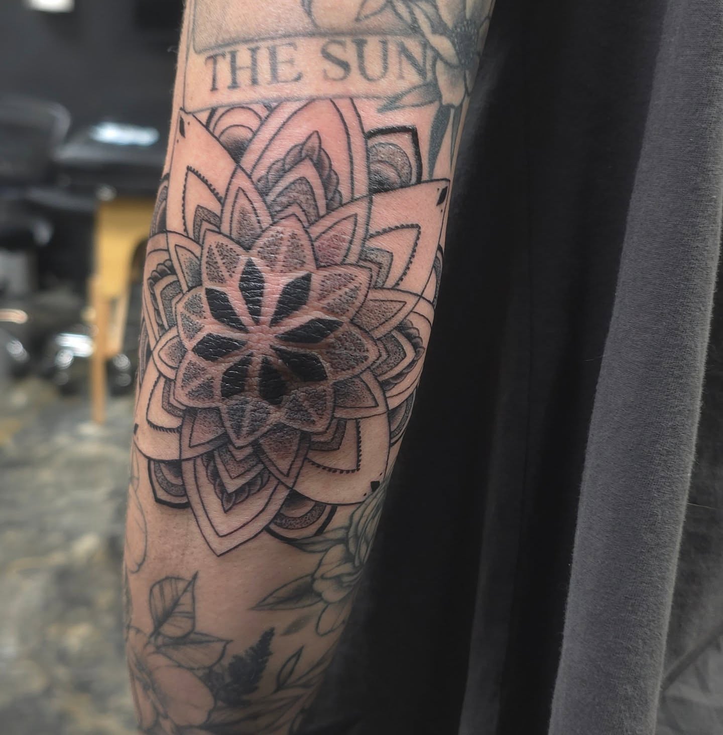 Lotus flower geometric tattoo on the forearm by Trinity