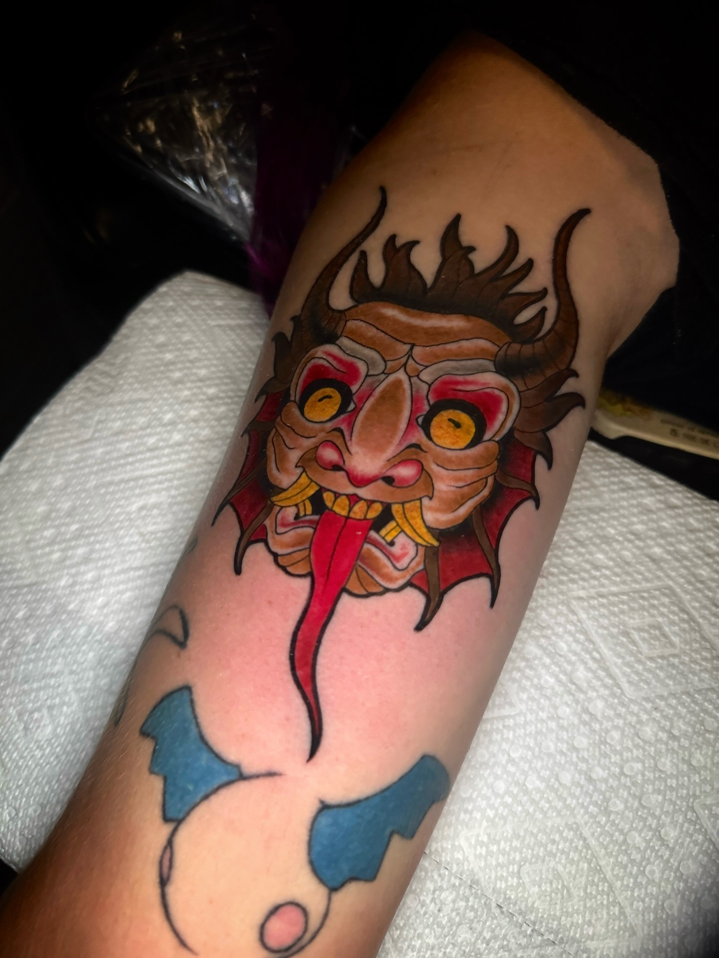 Demon mask American traditional tattoo on the forearm by Brett Brown