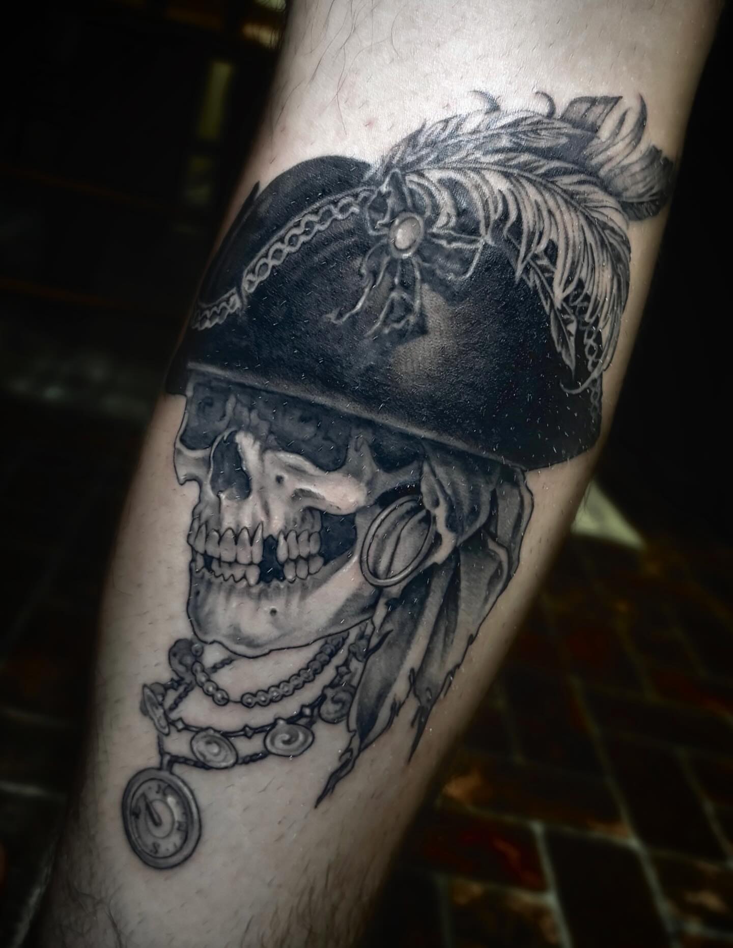 Skull wearing pirate hat realism tattoo on the forearm by Tad Fulkerson, San Francisco, California