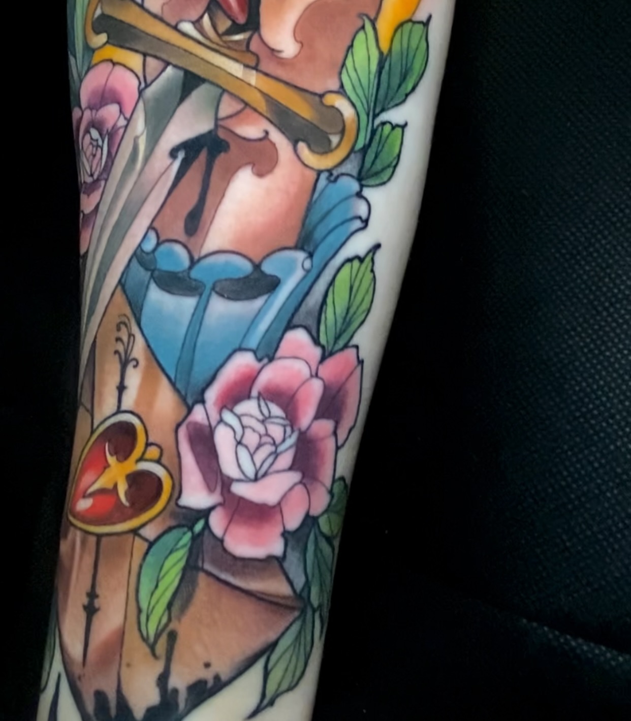 Flute player with roses American traditional tattoo on the forearm by ＊ 𝙴𝚁𝙸𝙺𝙰 𝚆𝙷𝙸𝚃𝙴 ＊ 𝙱𝙻𝚄𝙴 𝚃𝙾𝚁𝙲𝙷 𝚃𝙰𝚃𝚃𝙾𝙾