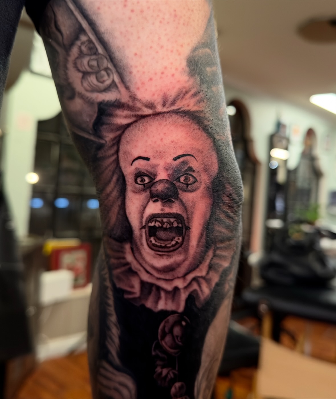 Clown realism tattoo on the forearm by Marisa Biddle