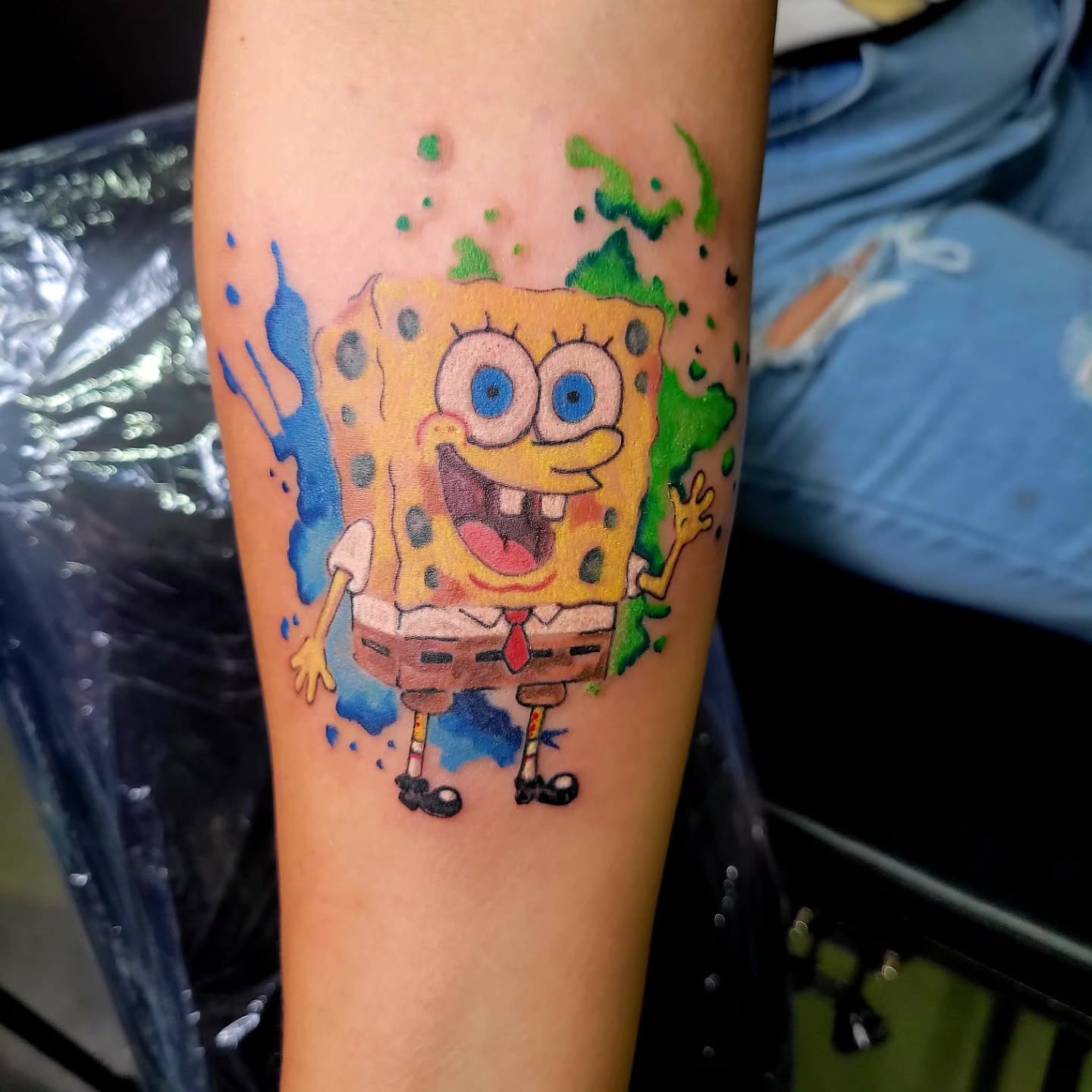 SpongeBob SquarePants watercolor tattoo on the forearm by Naez Ink AKA Renae Madison, Macomb, Illinois