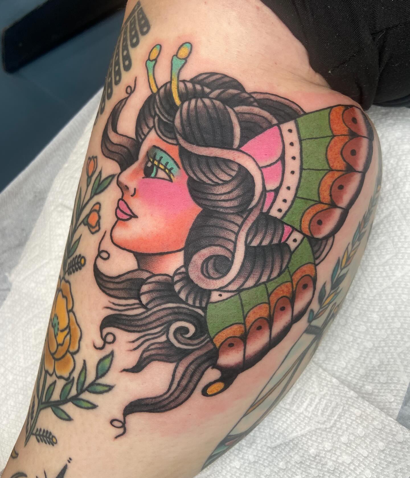 Woman with butterfly American traditional tattoo on the upper arm by nicholas mcevoy, Boston, Massachusetts
