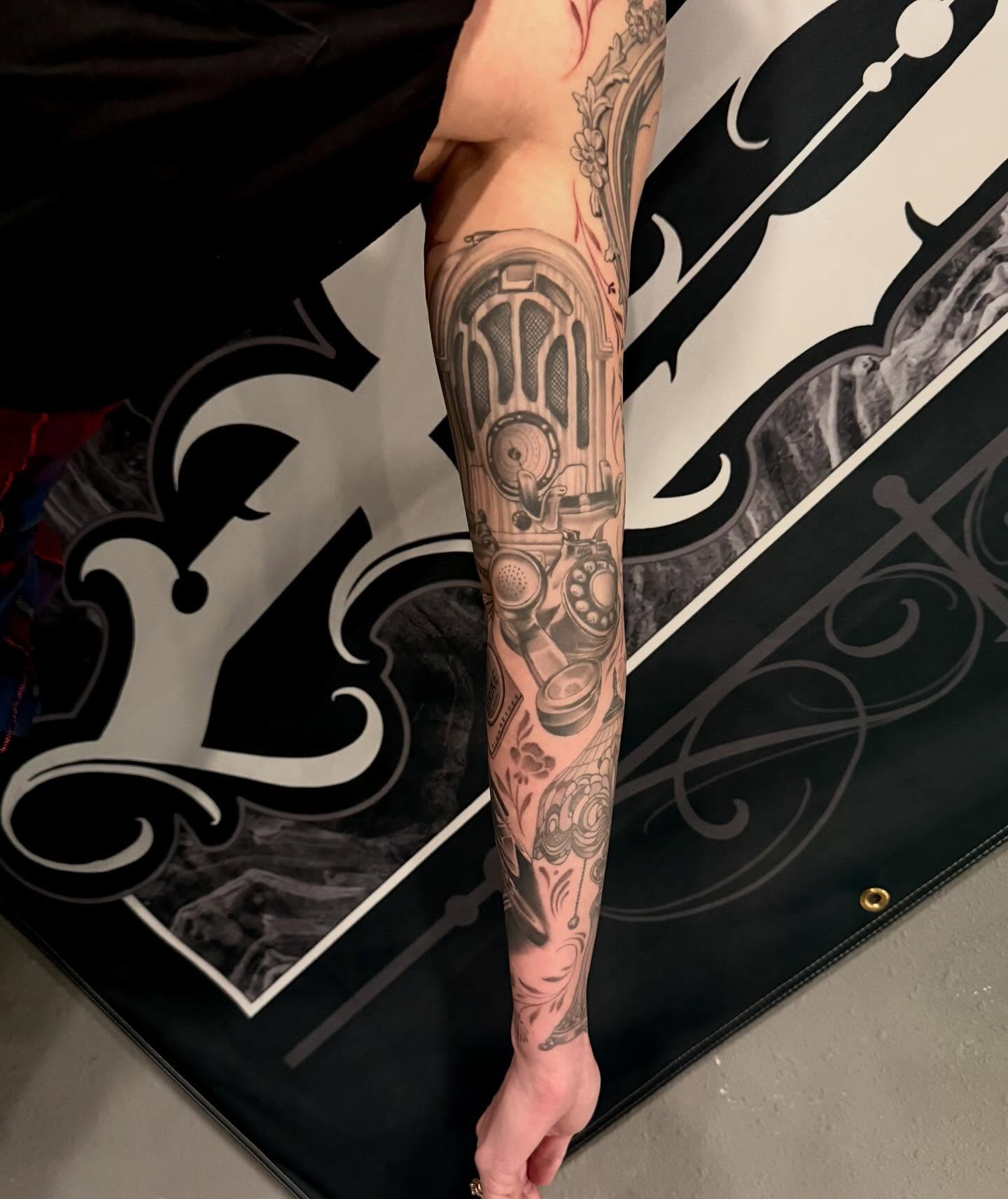 Mechanical device black and grey tattoo on the forearm by Cody Pappas