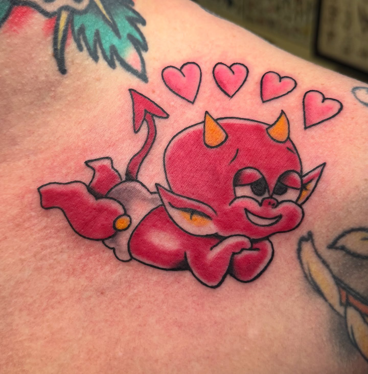 Cute devil American traditional tattoo on the upper arm by Bre