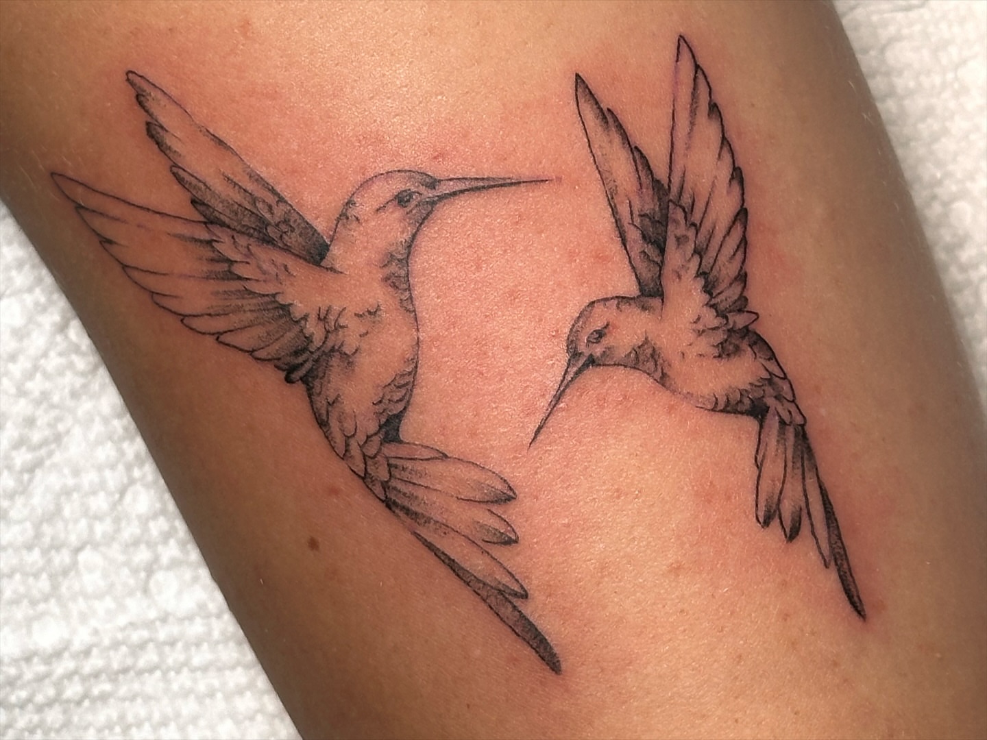 Hummingbirds black and grey tattoo on the forearm by James Nelson