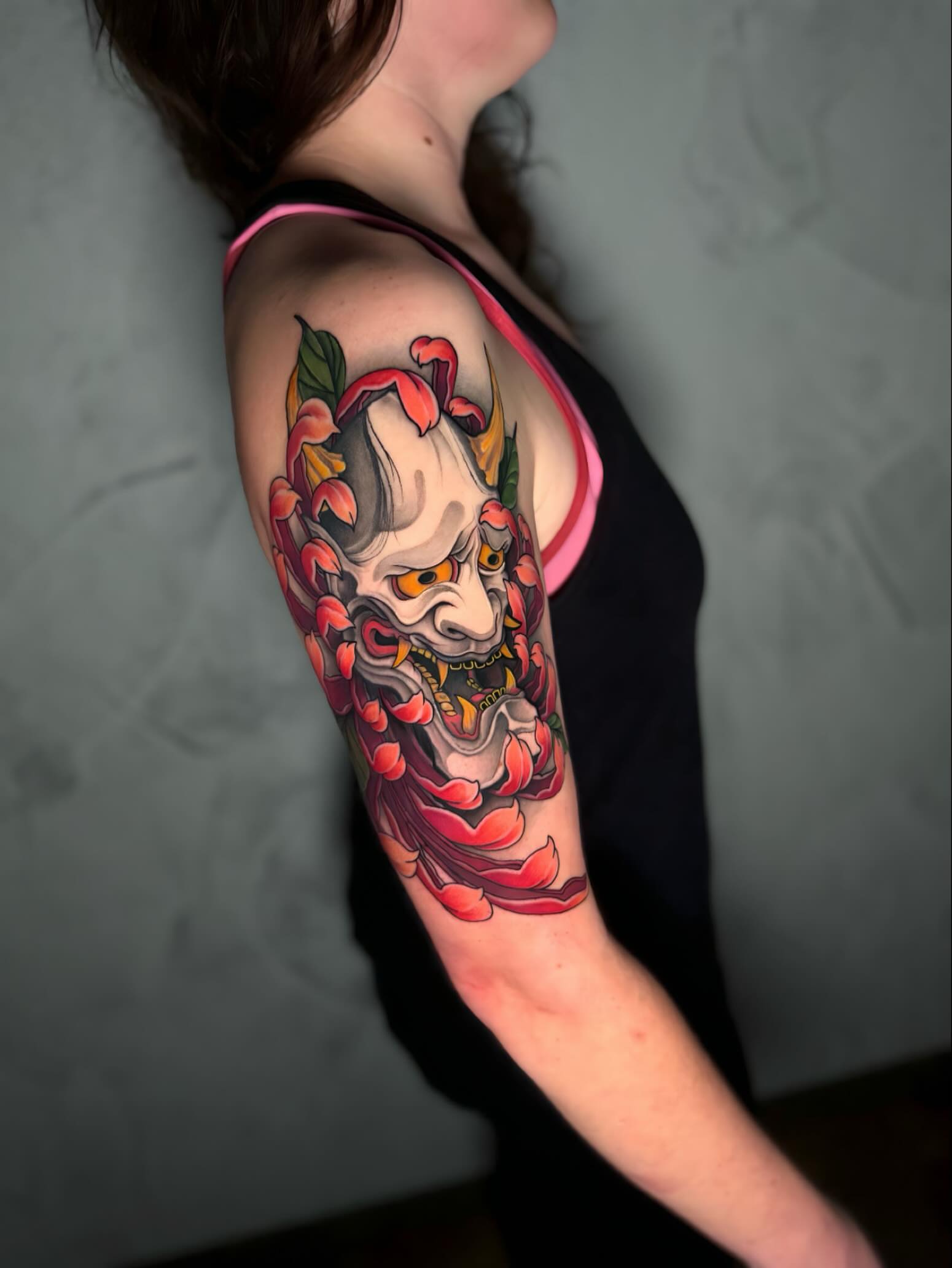 Mask with floral elements japanese irezumi tattoo on the forearm by Ethan Lund