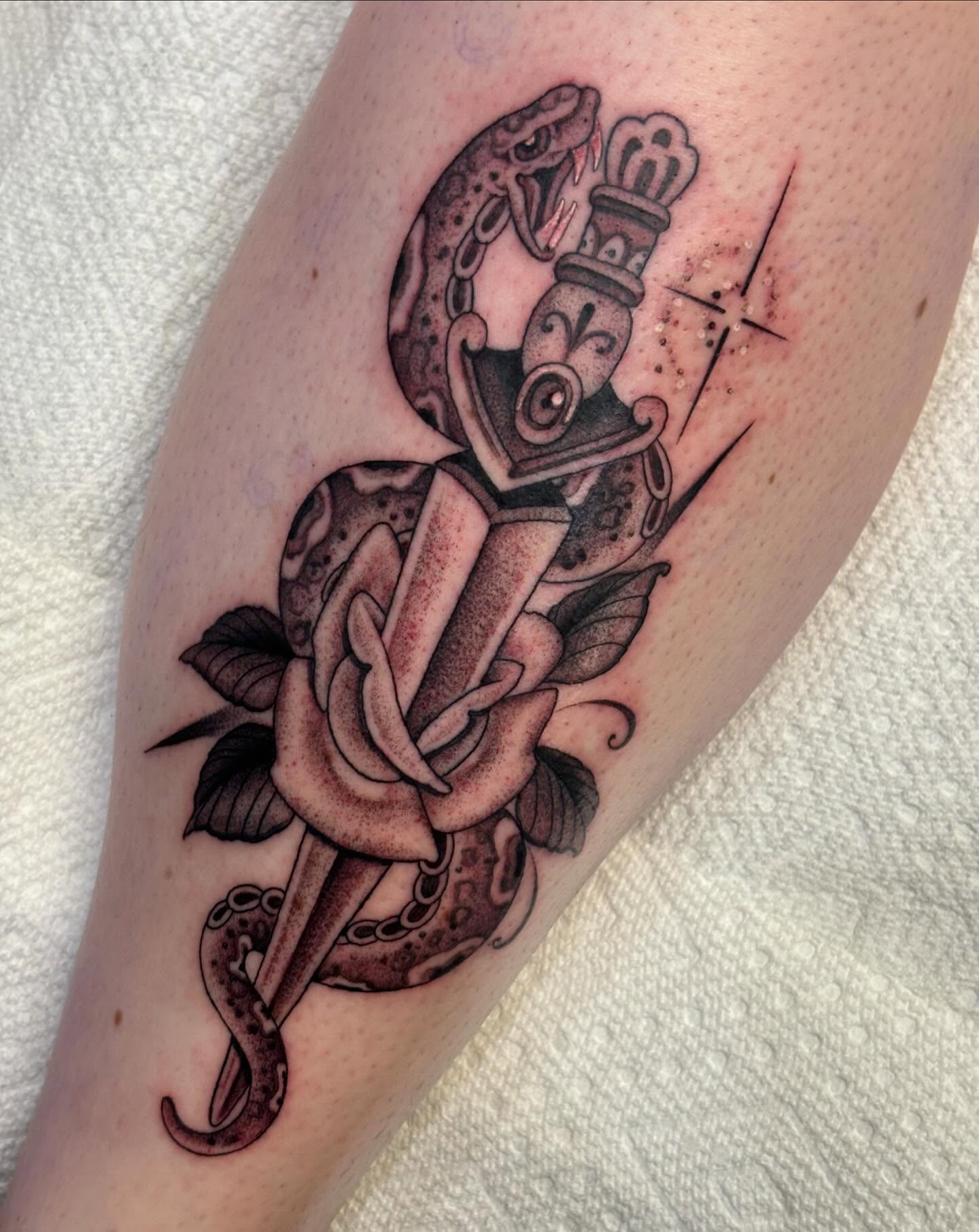 Snake and dagger black and grey tattoo on the forearm by Storm