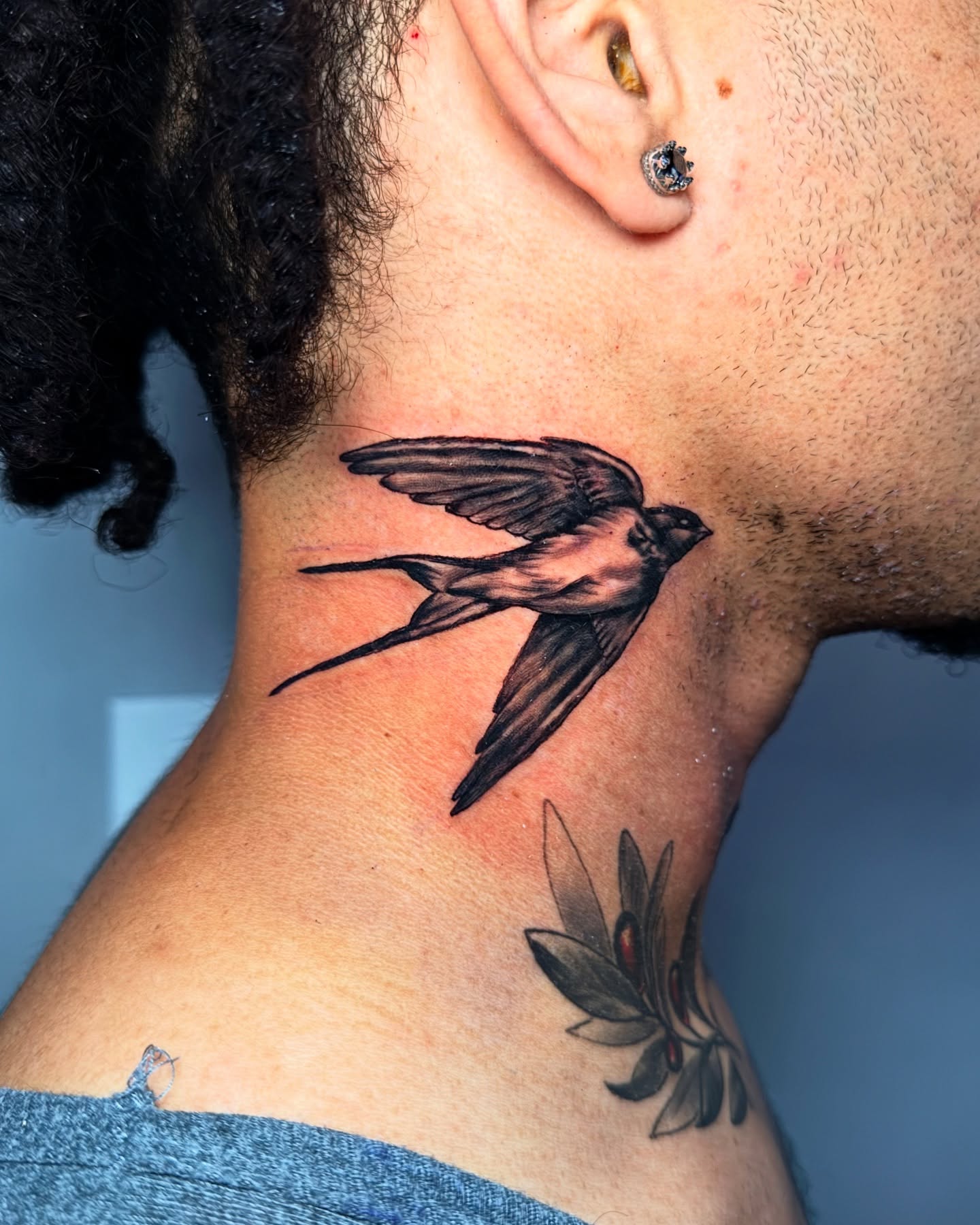 Swallow and flower realism tattoo on the neck by Arthur Volper