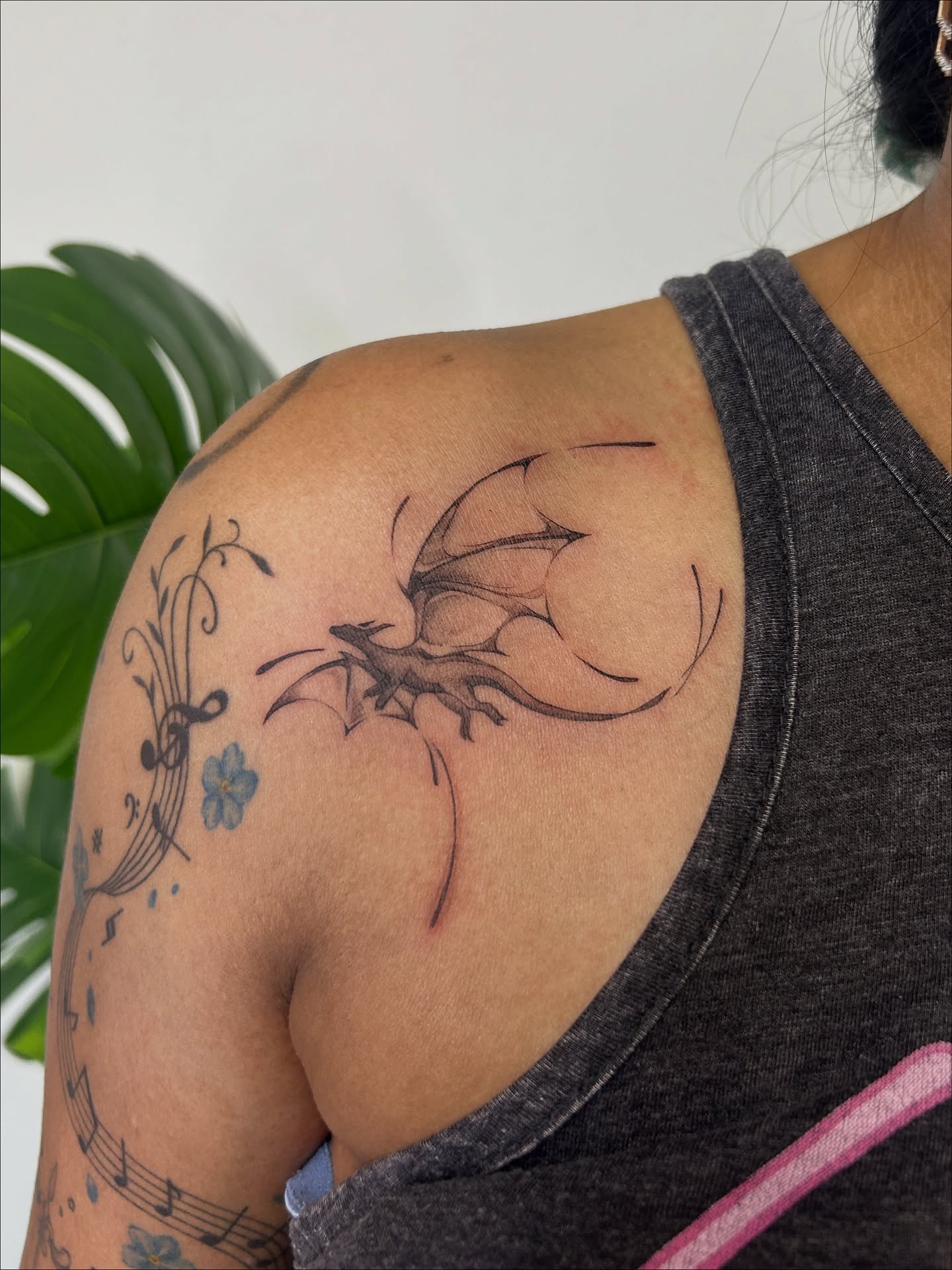 Dragon and floral black and grey tattoo on the shoulder by Miri