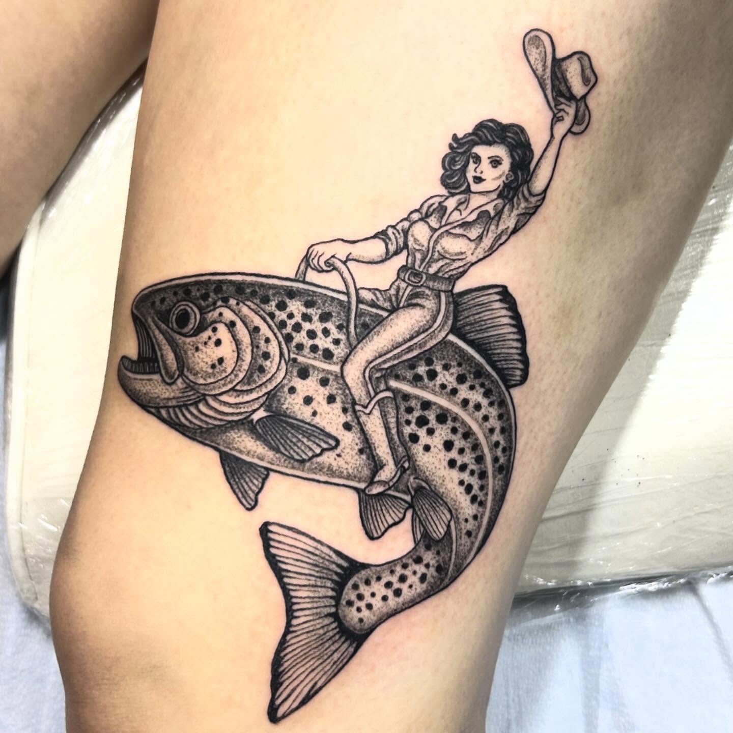 Woman riding fish dotwork tattoo on the thigh by Nikki Power