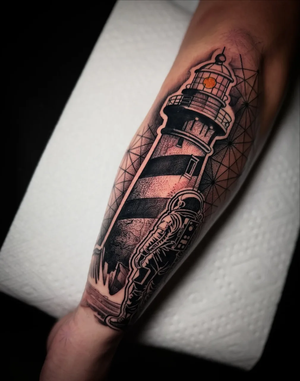 Lighthouse geometric tattoo on the forearm by David Mushaney