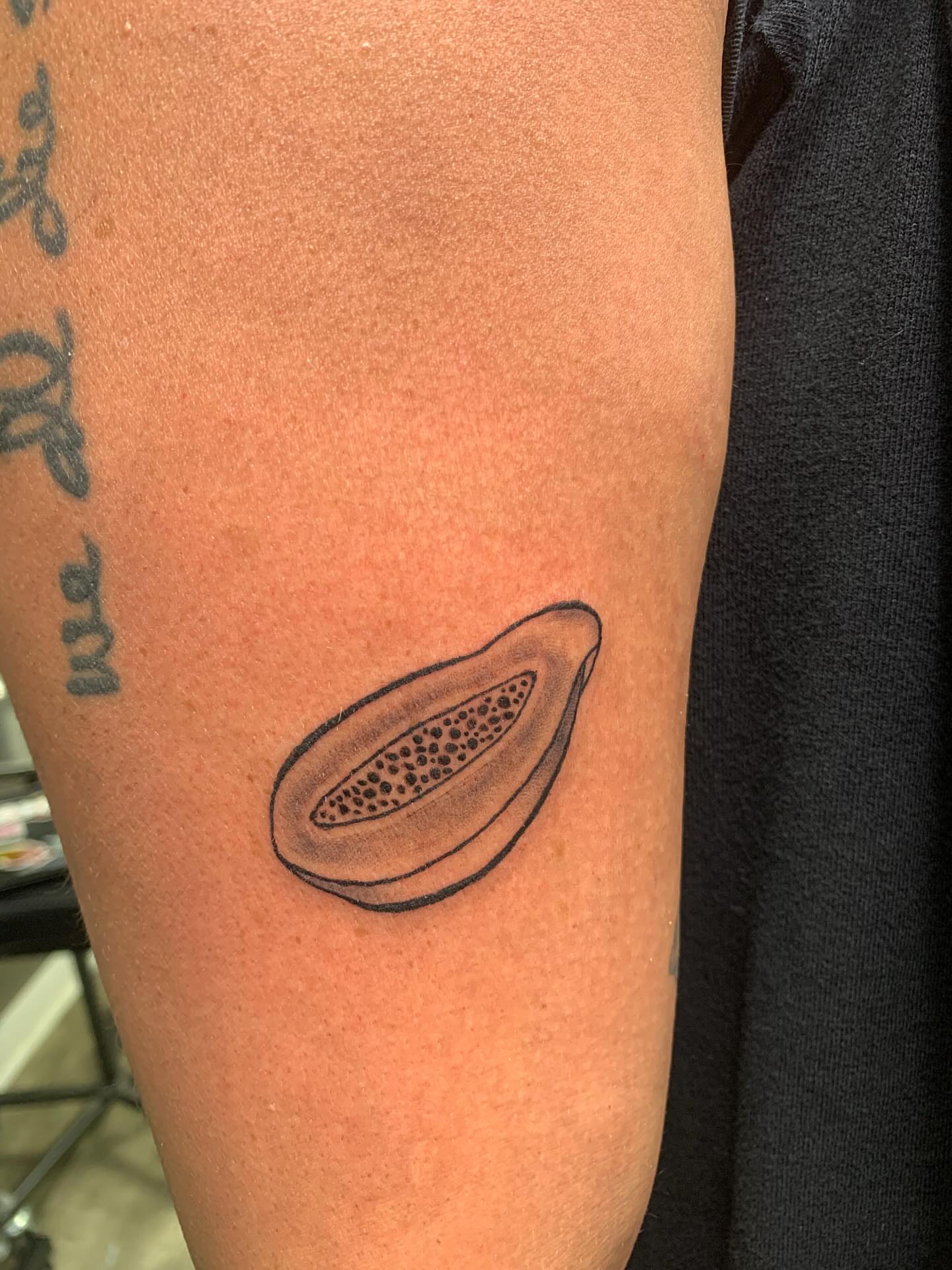 Papaya black and grey tattoo on the forearm by Devon