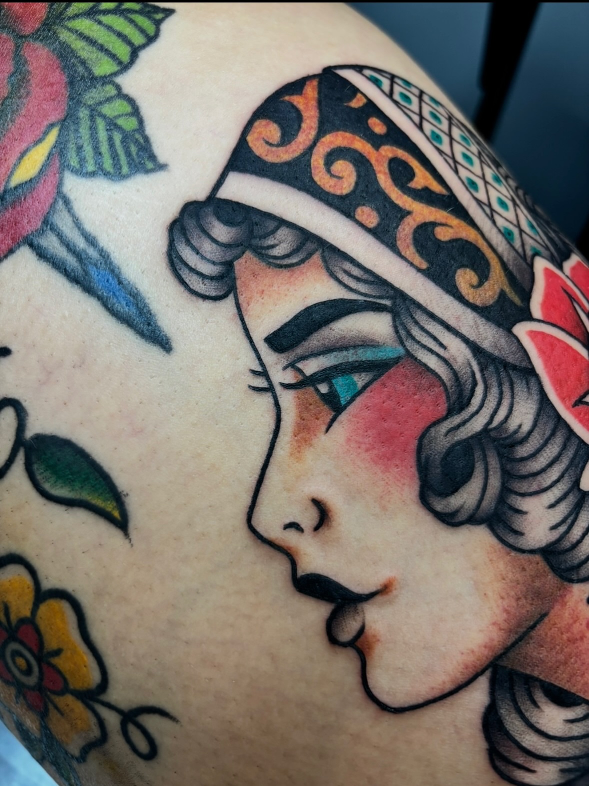 Woman's profile American traditional tattoo on the shoulder by Dyllan Shipley