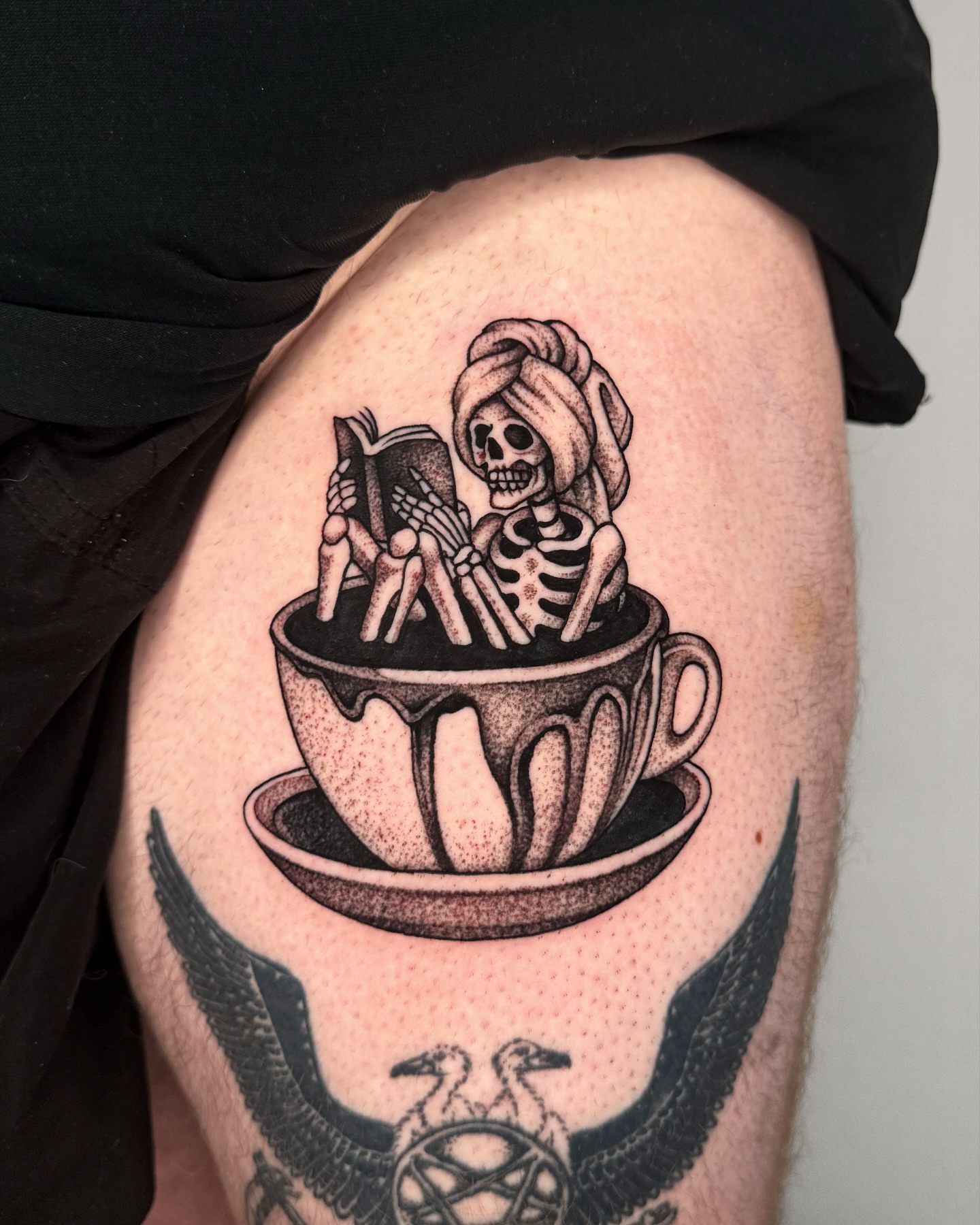 Skeleton reading in teacup dotwork tattoo on the thigh by Jae Traditional Tattoo