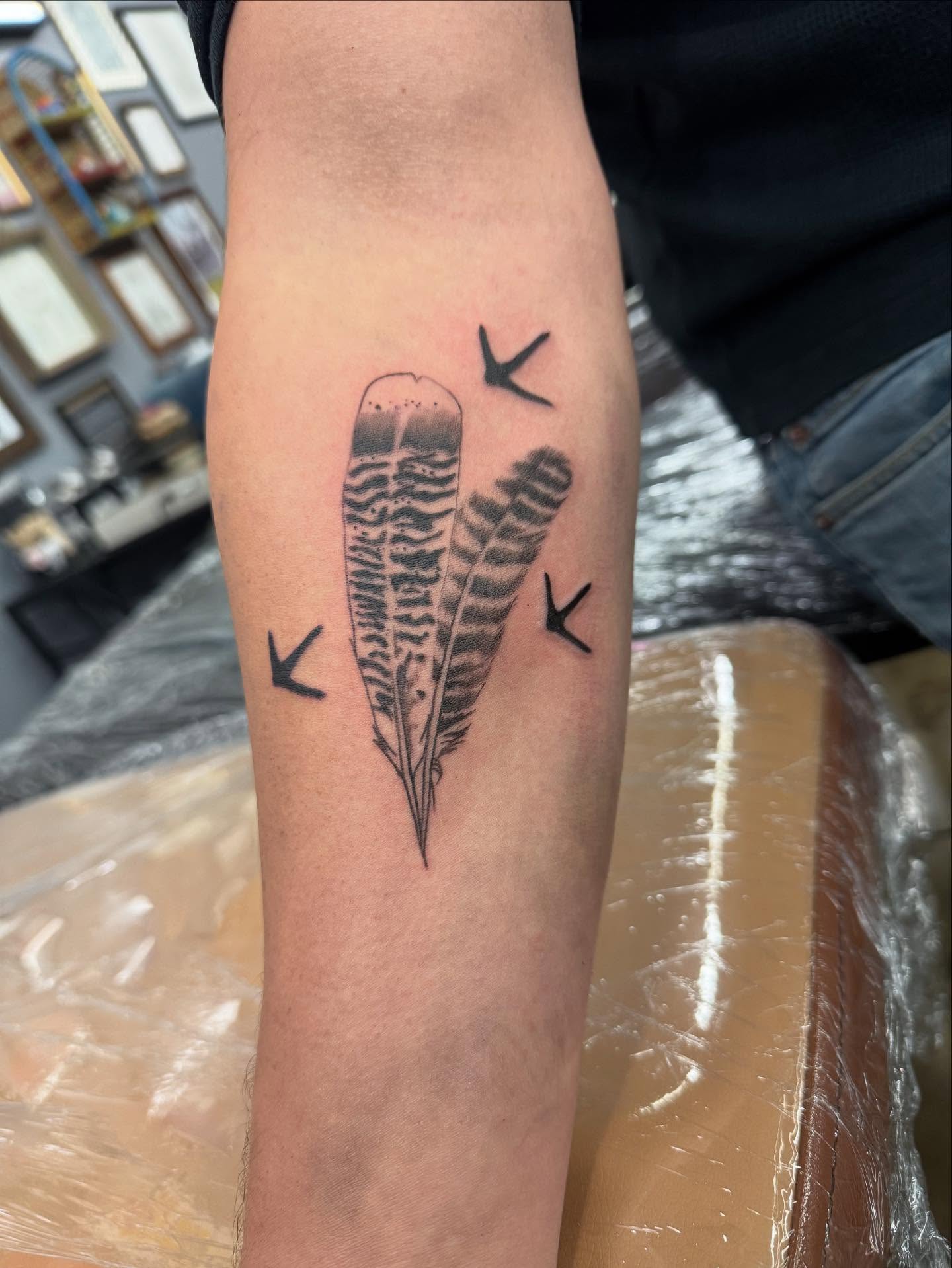 Feather black and grey tattoo on the forearm by Willi Tattoos👹