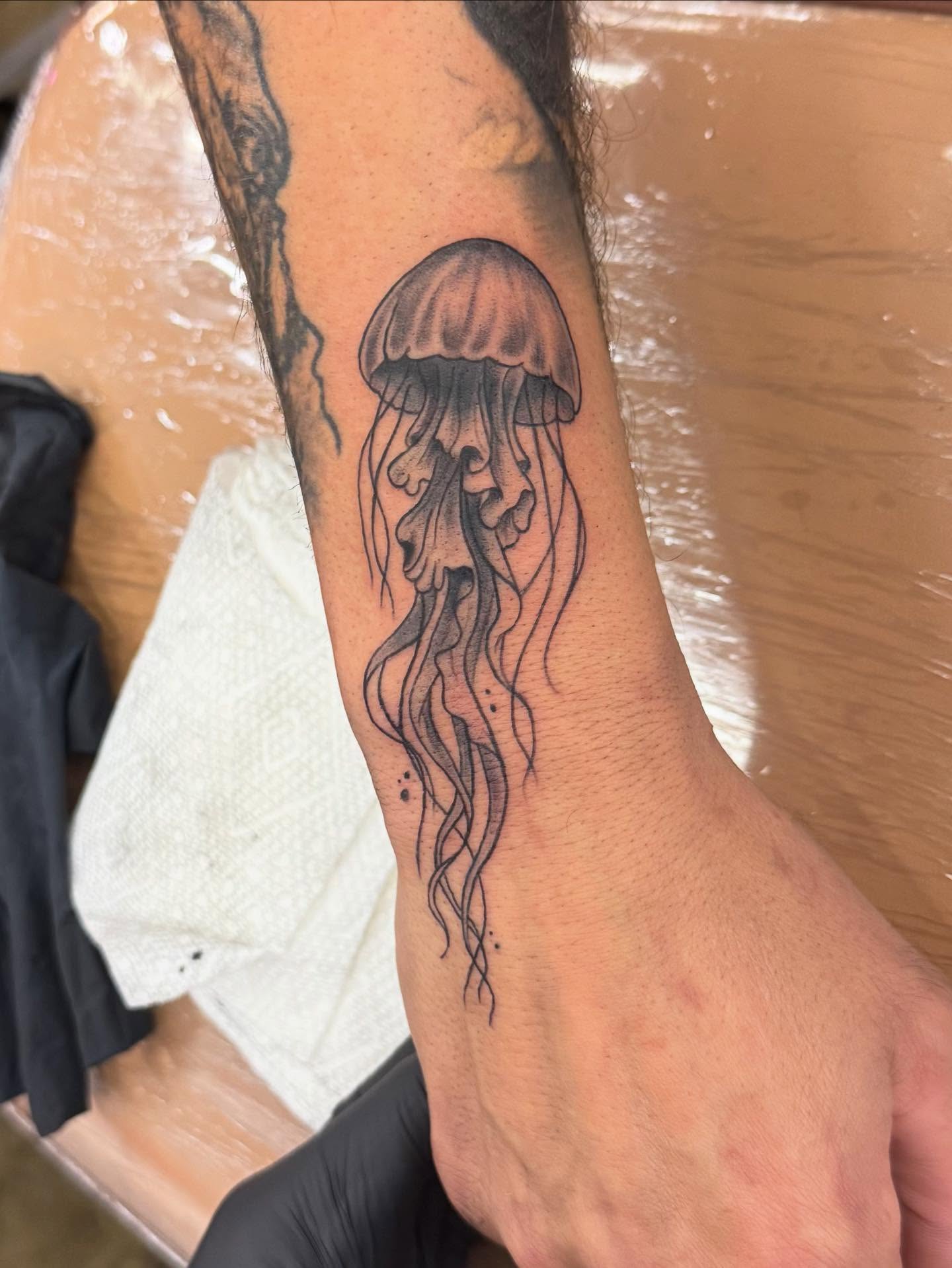 Jellyfish black and grey tattoo on the forearm by Willi Tattoos👹