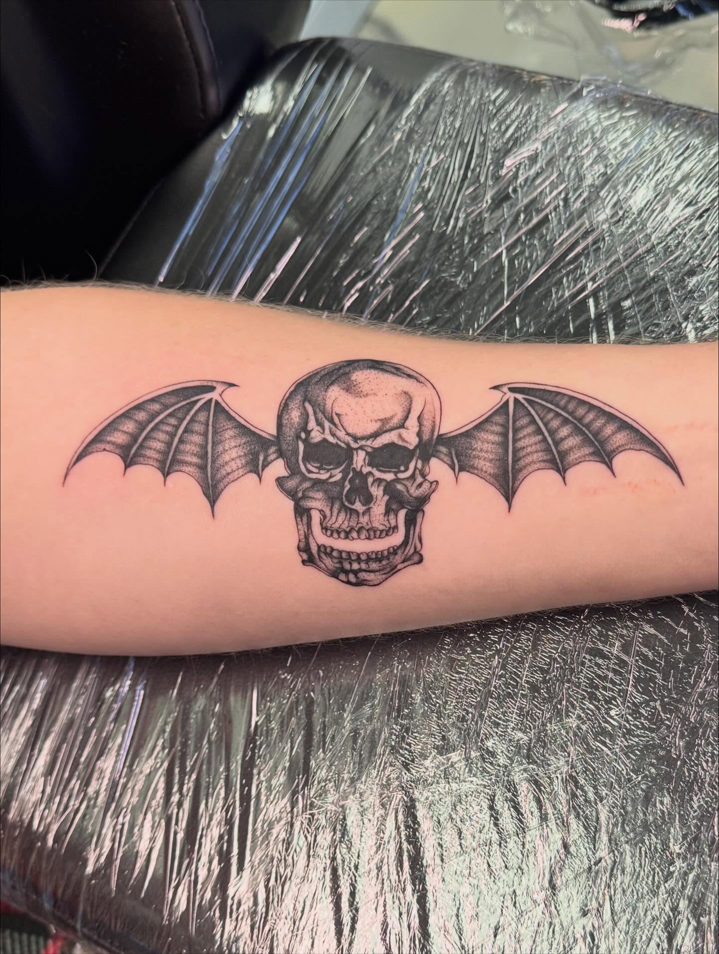 Bat skull black and grey tattoo on the forearm by haylie
