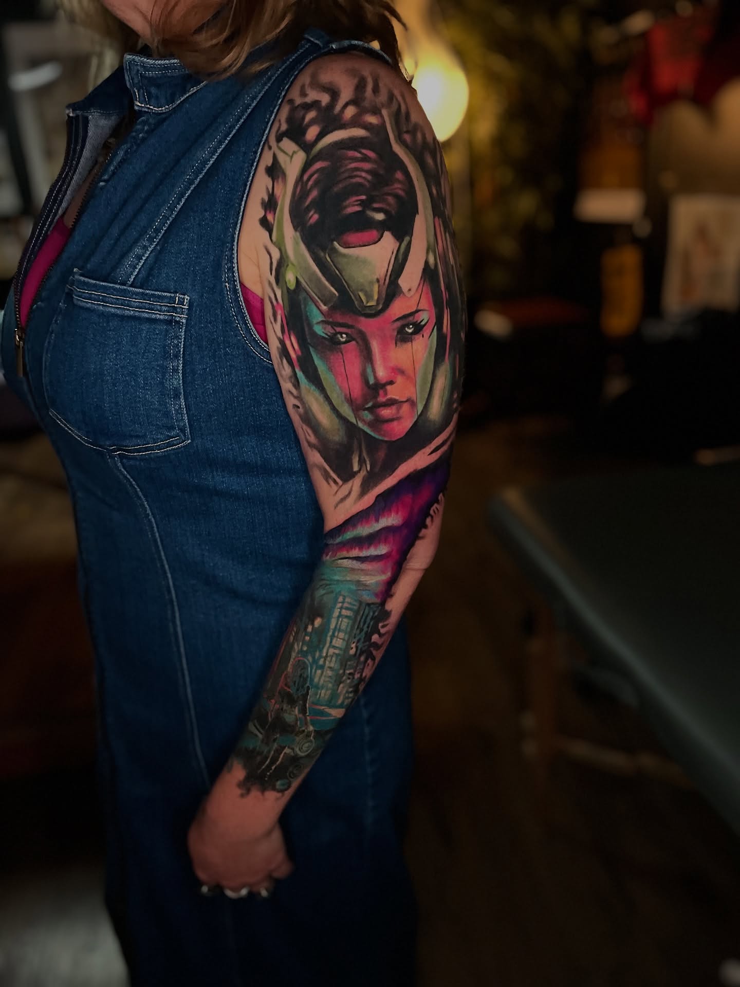 Woman's face realism tattoo on the upper arm by Dean Rogers