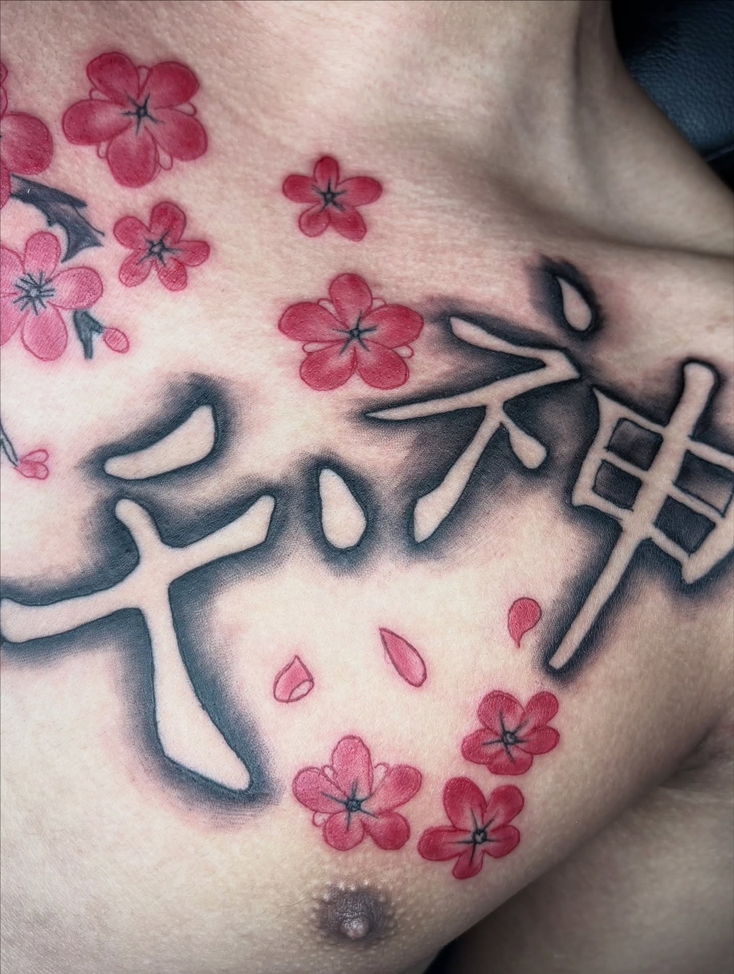 Cherry blossoms and kanji japanese irezumi tattoo on the chest by Maleek Inkz
