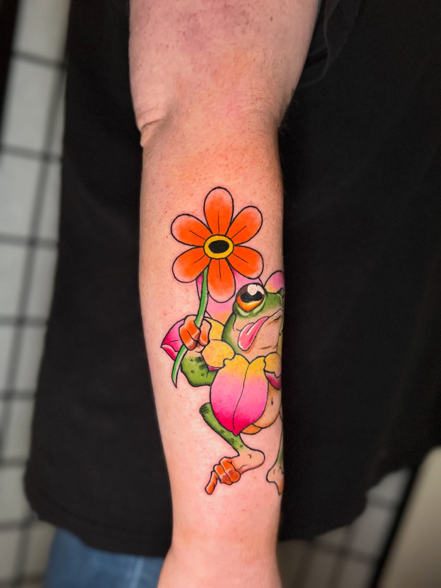Frog with flower new school tattoo on the forearm by Austin Poliszuk, Minneapolis, Minnesota