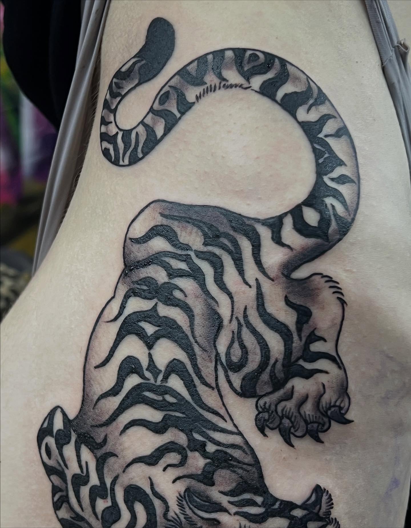 Lion and snake tribal tattoo on the thigh by Sav
