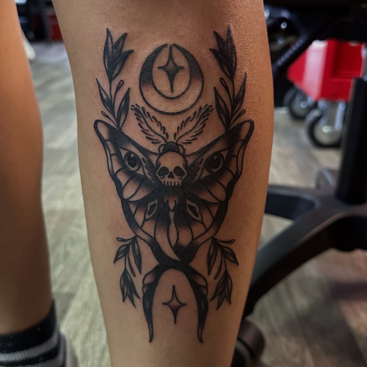 Skull and wings black and grey tattoo on the forearm by Ash Nicole Painterly, San Diego, California