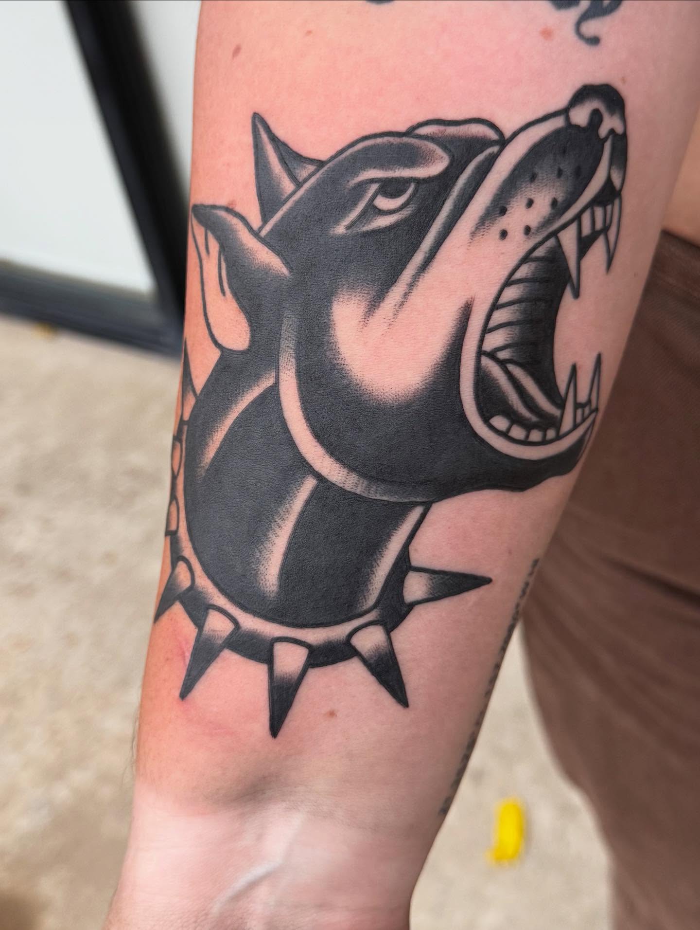Roaring dog American traditional tattoo on the forearm by Brent G
