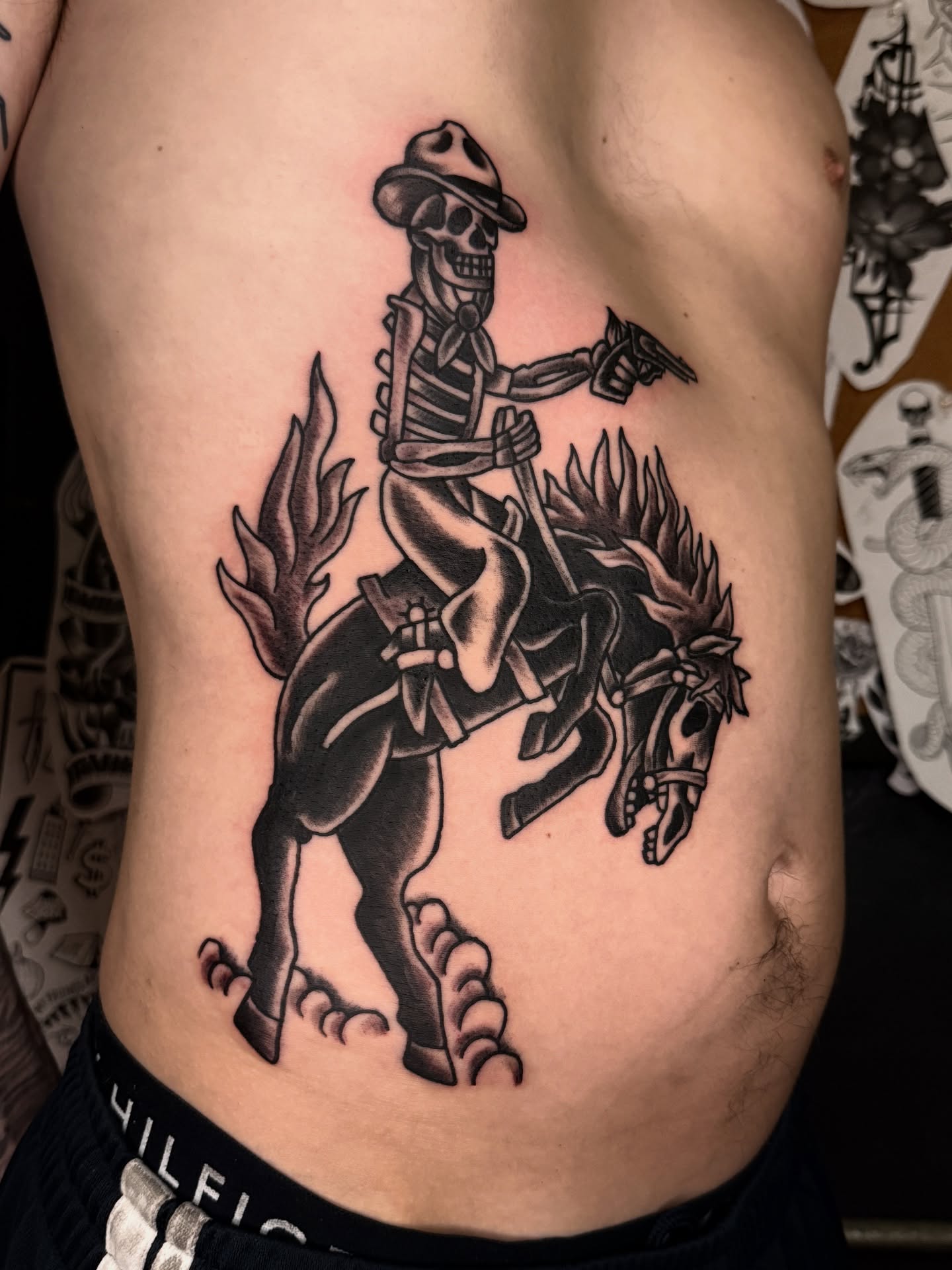 Skeleton rider American traditional tattoo on the ribs by Andre Guerra