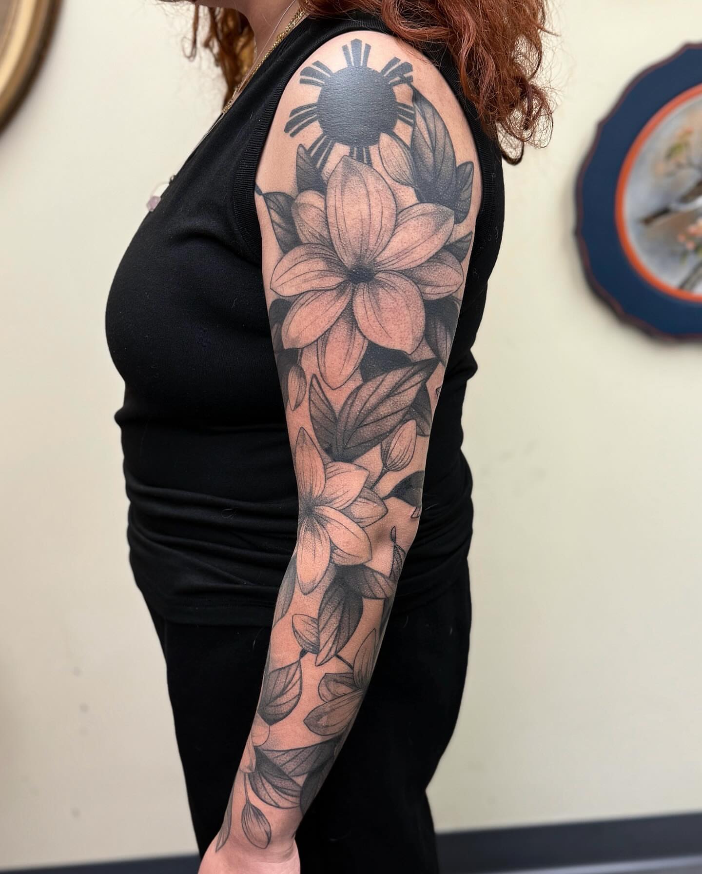 Lotus flowers realism tattoo on the upper arm by jada