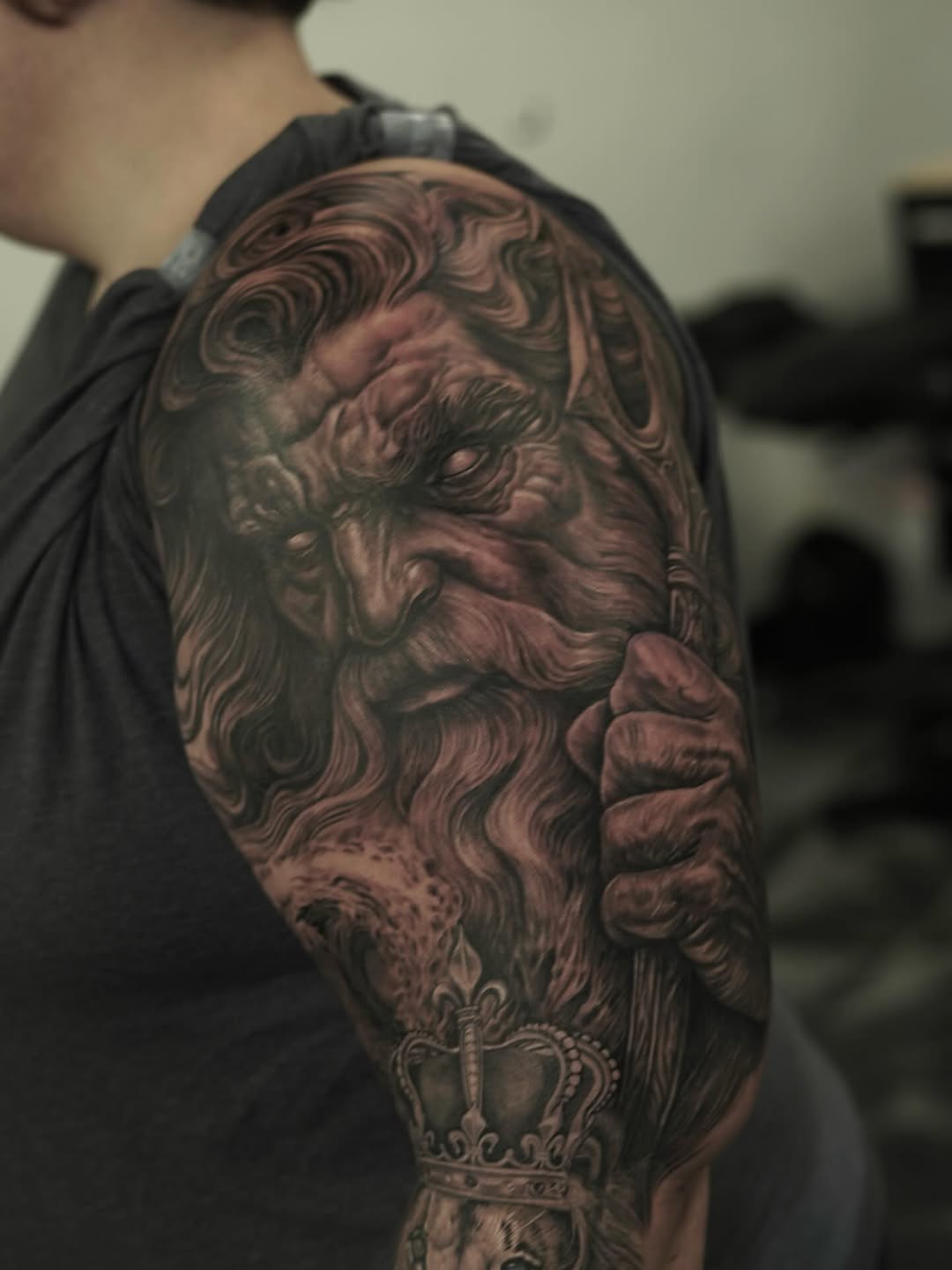 Old man with beard and crown surrealism tattoo on the shoulder by Nelson Tellez