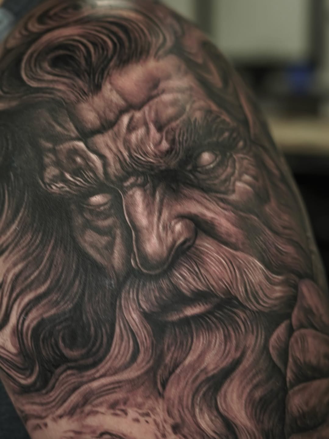 Old man's face surrealism tattoo on the shoulder by Nelson Tellez