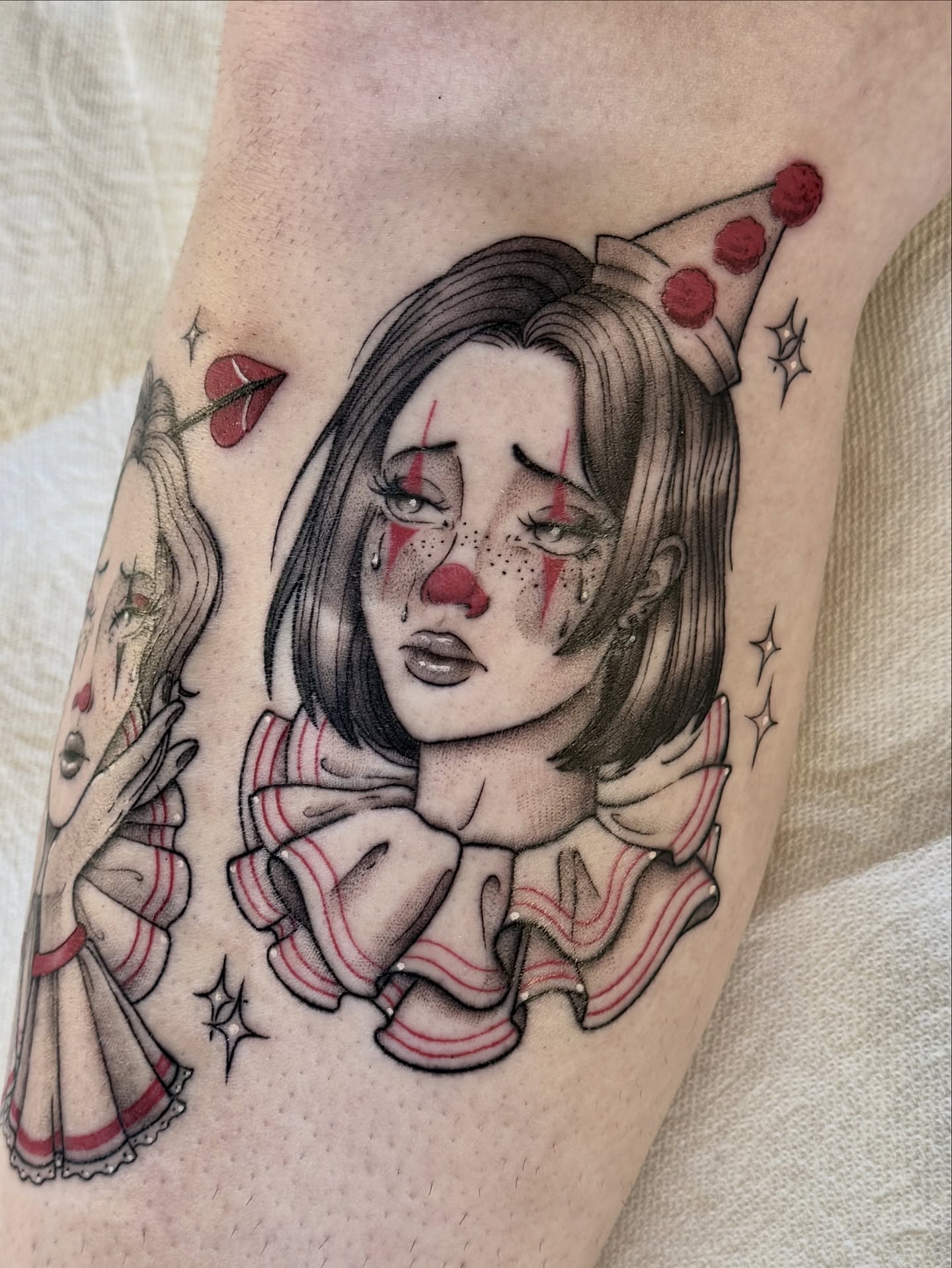 Clown girl dark realism tattoo on the forearm by Hannah May, La Mesa, California
