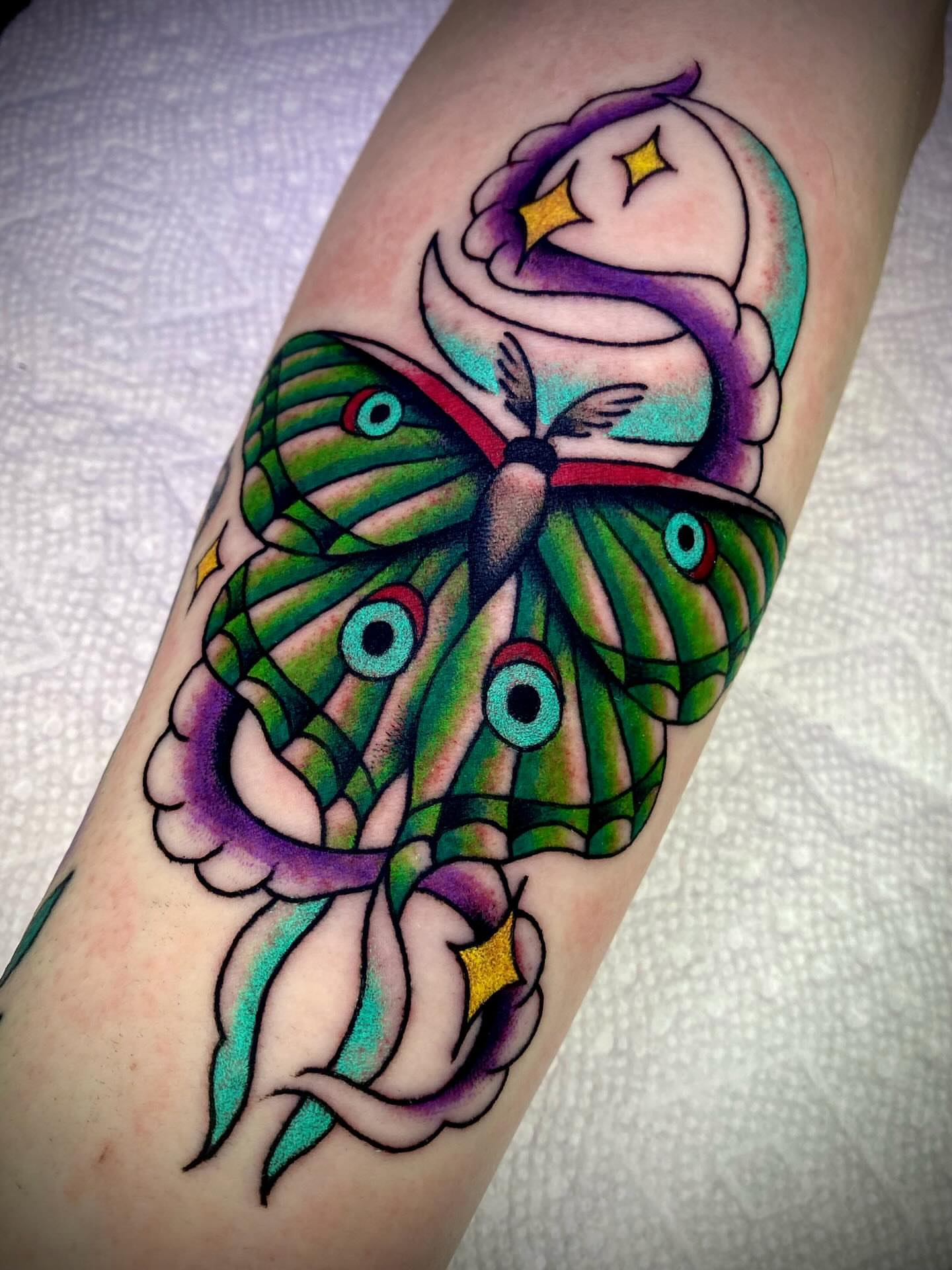 Butterfly and owl American traditional tattoo on the forearm by Zach Knisley (Wiz)