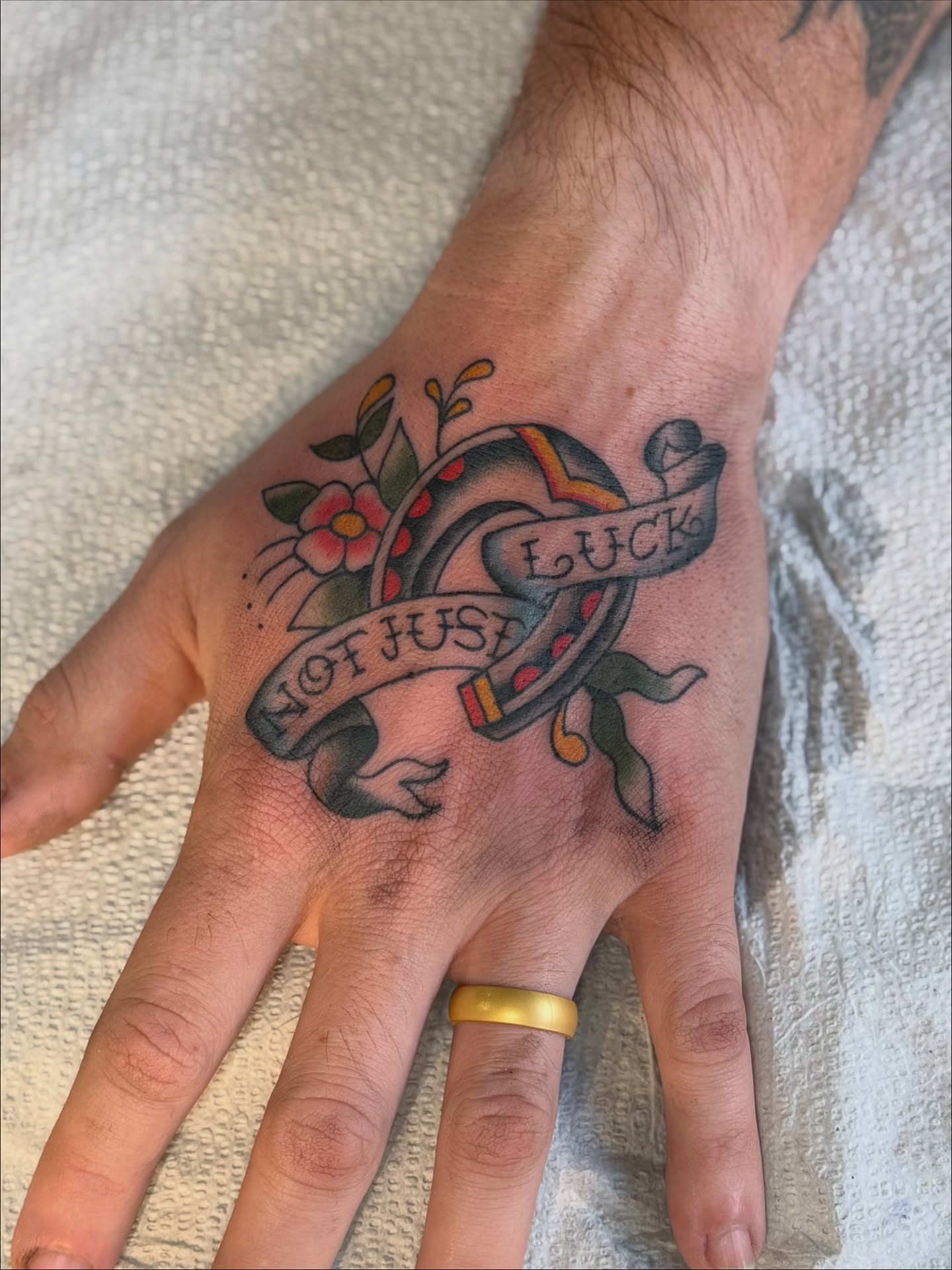 Heart with banner American traditional tattoo on the hand by Devin Derbes