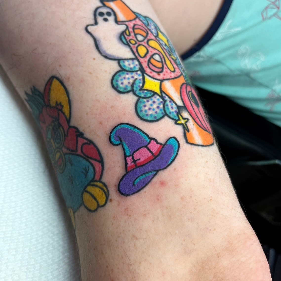 Colorful cartoon characters American traditional tattoo on the forearm by Alena McDonald