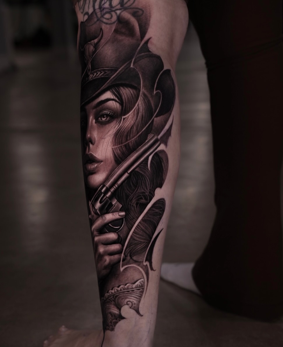 Woman with a gun realism tattoo on the forearm by @_garart_