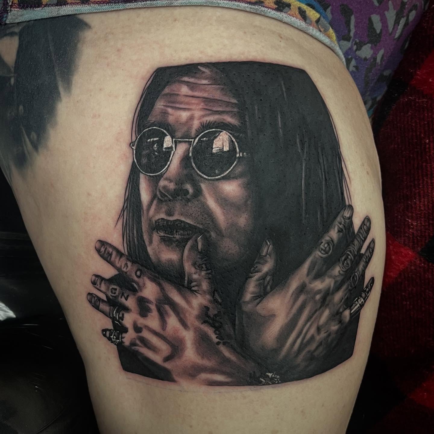 Portrait of a person realism tattoo on the thigh by Taylor Santavicca