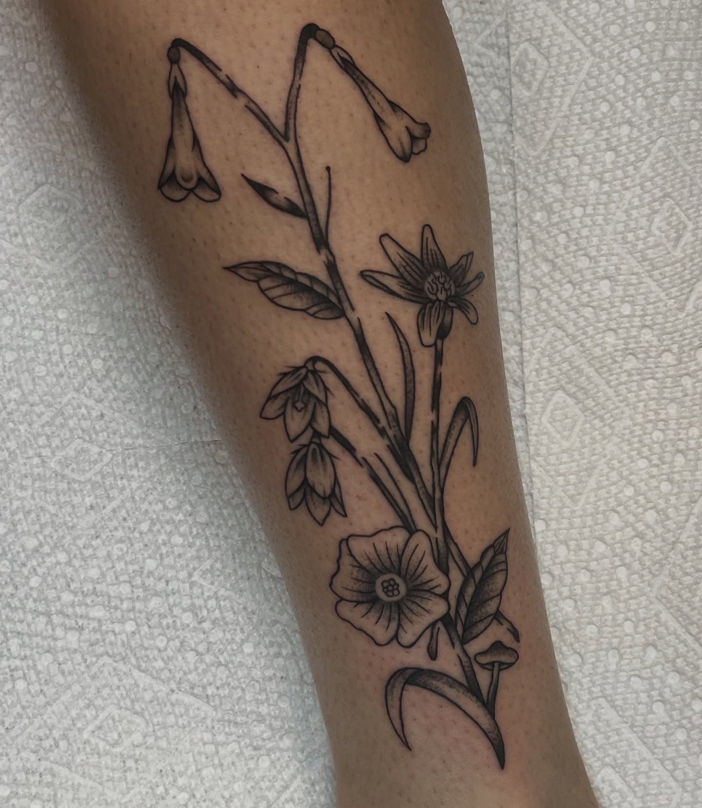 Botanical flowers black and grey tattoo on the forearm by August B., Renton, Washington
