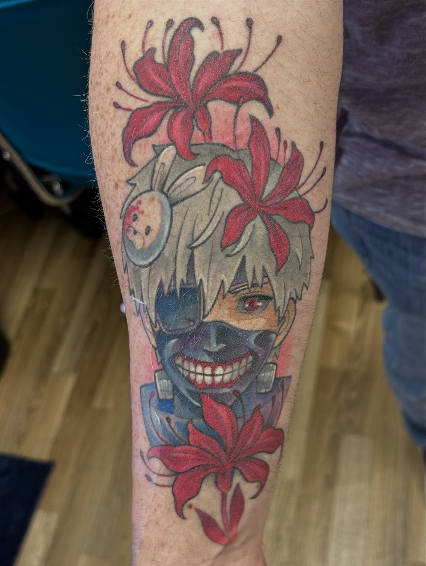 Anime character with flowers anime tattoo on the forearm by Mando Castro