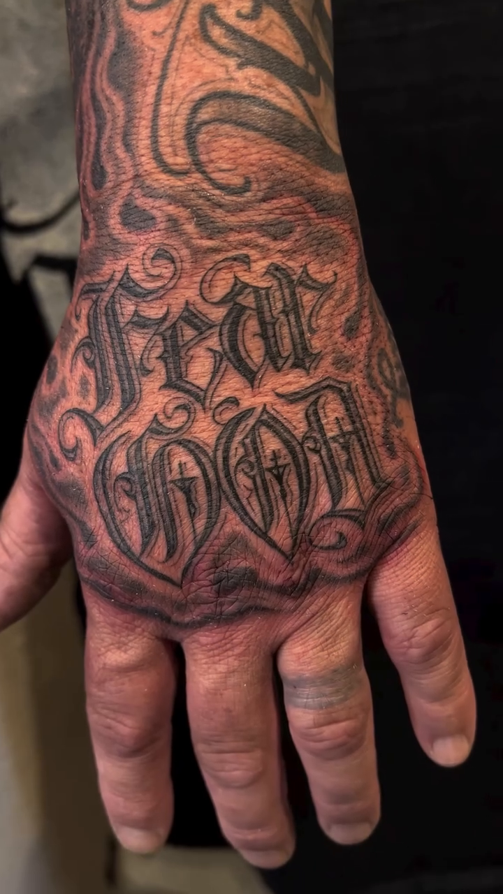 Fear God lettering script tattoo by F e A R