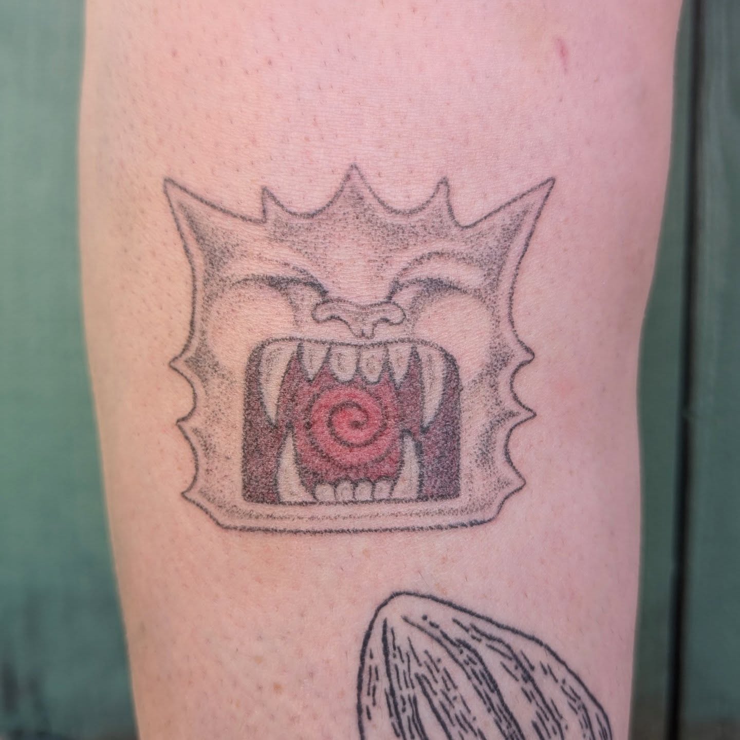 Fangs and spiral dotwork tattoo on the forearm by theo, Portland, Oregon
