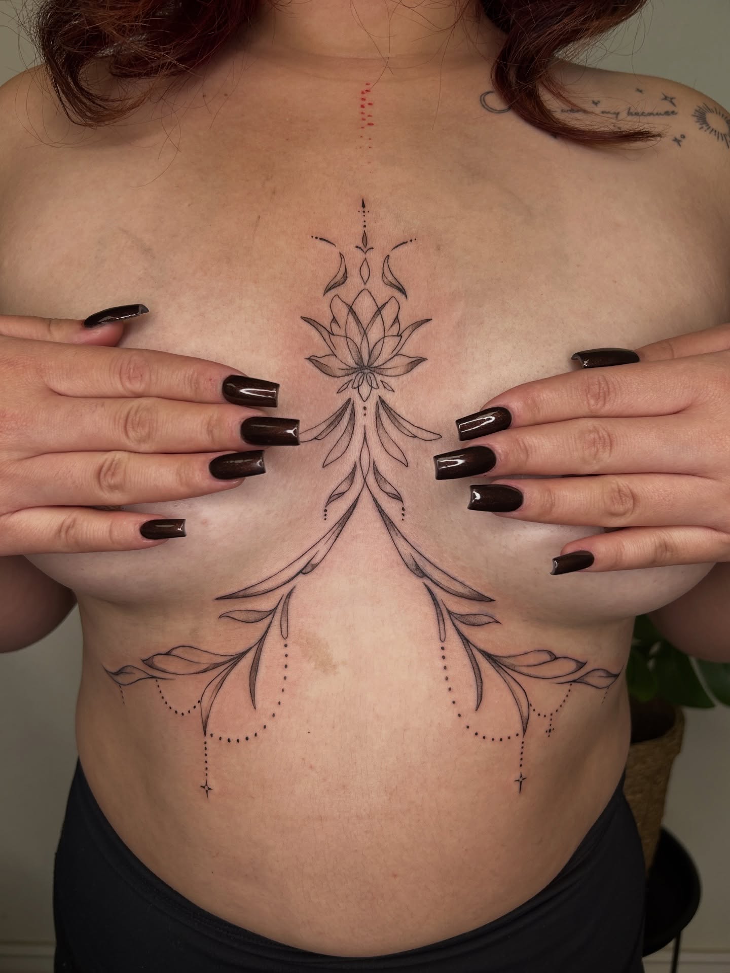Lotus flower dotwork tattoo on the chest by Miri
