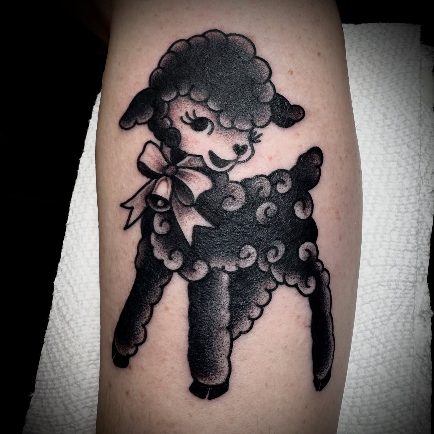 Sheep black and grey tattoo on the forearm by Kristen