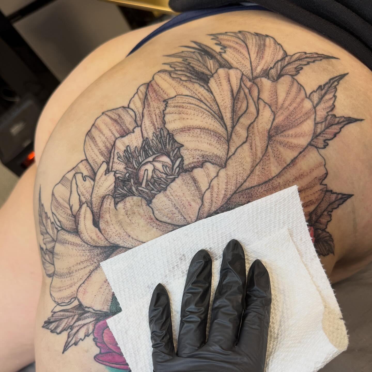 Peony flower dotwork tattoo on the thigh by Aura Noire