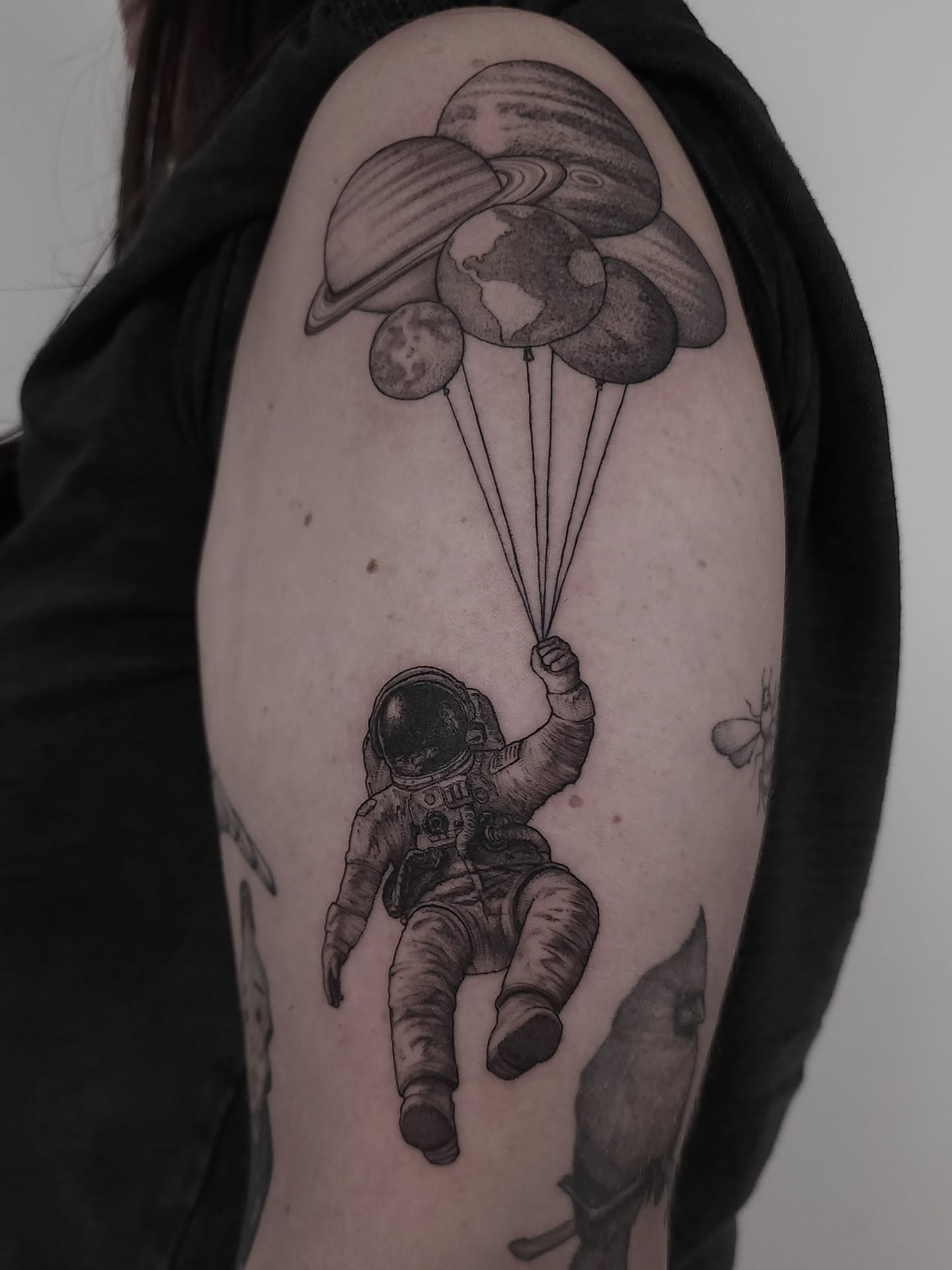 Astronaut with planets realism tattoo on the upper arm by ๐ฏ๐๐๐๐ ๐ท๐๐๐๐