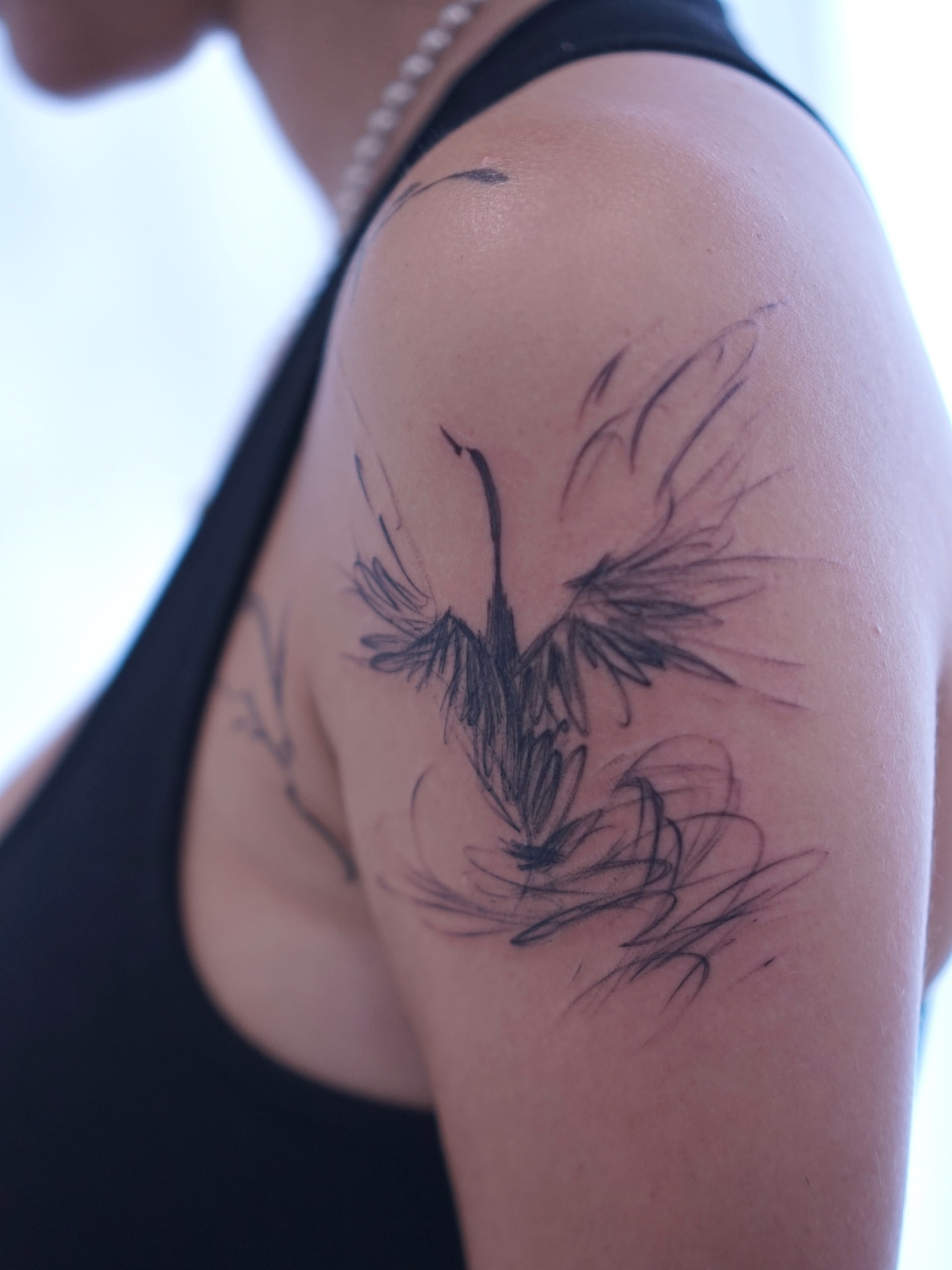 Bird black and grey tattoo on the shoulder by Young one 영원