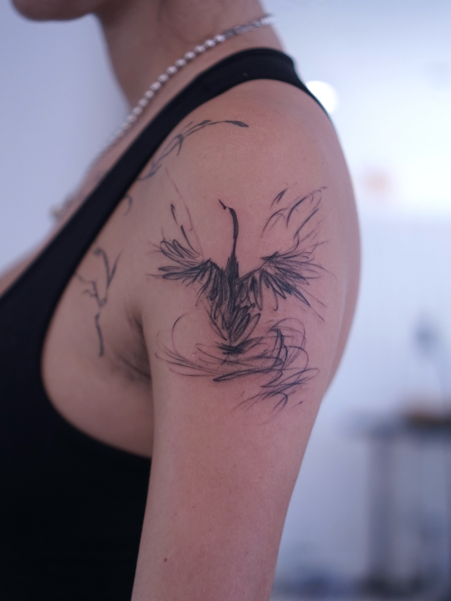 Bird black and grey tattoo on the shoulder by Young one 영원