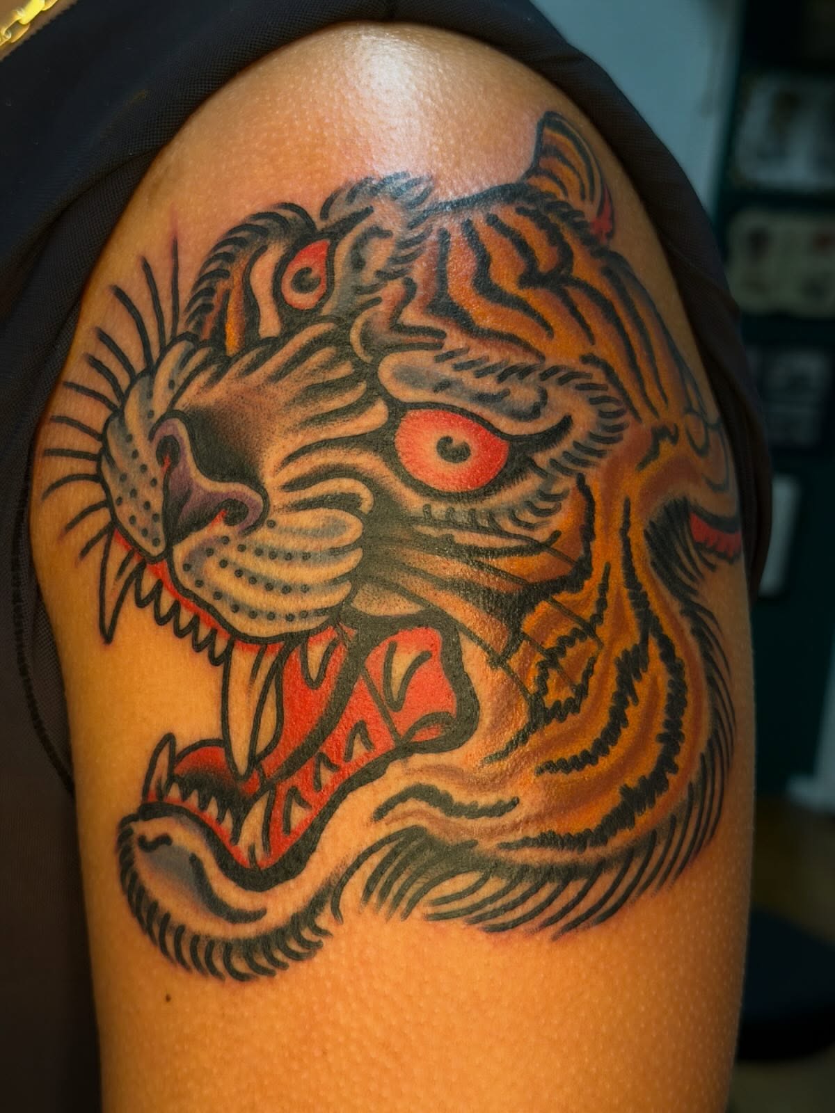 Tiger American traditional tattoo on the shoulder by Tony Kaplan